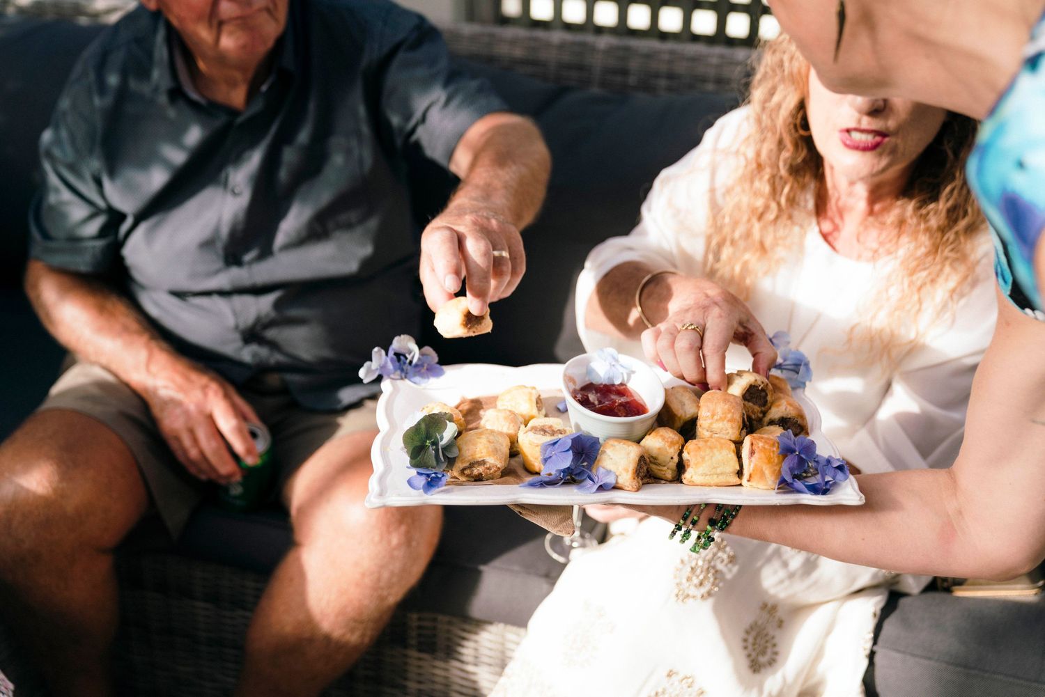 People sharing a casual meal together on outdoor patio furniture.