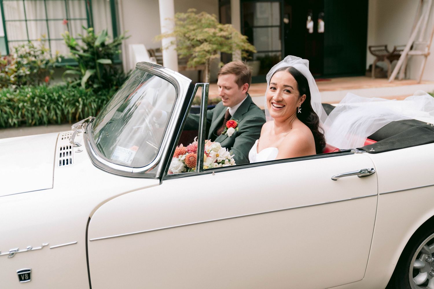 Classic white vintage car decorated for wedding transportation.