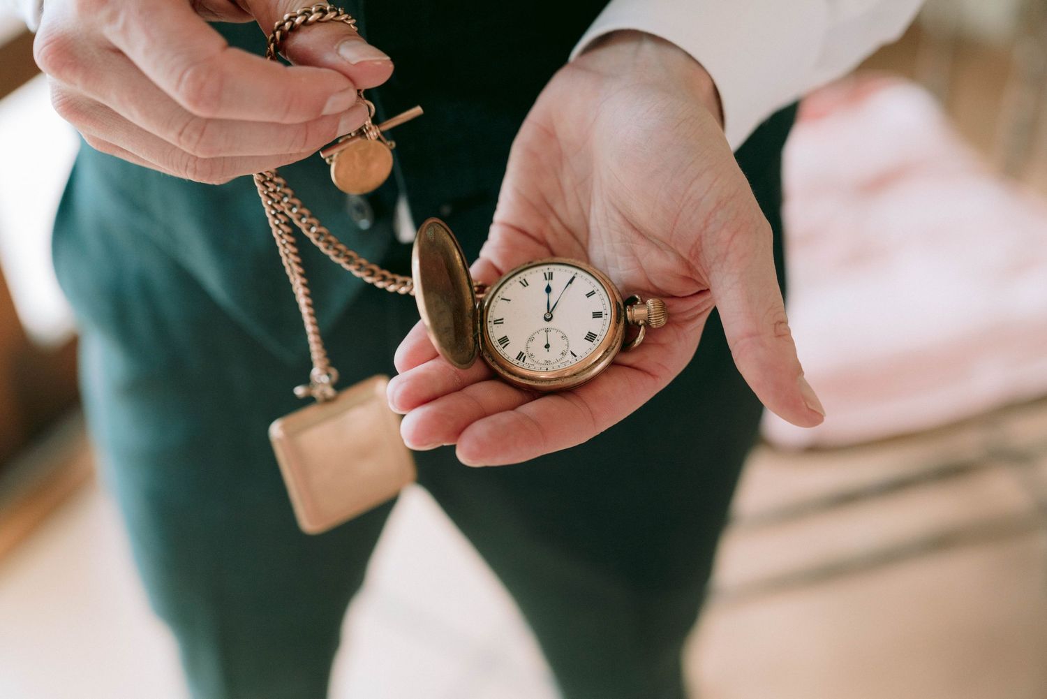 Vintage pocket watches and accessories displayed as wedding details.