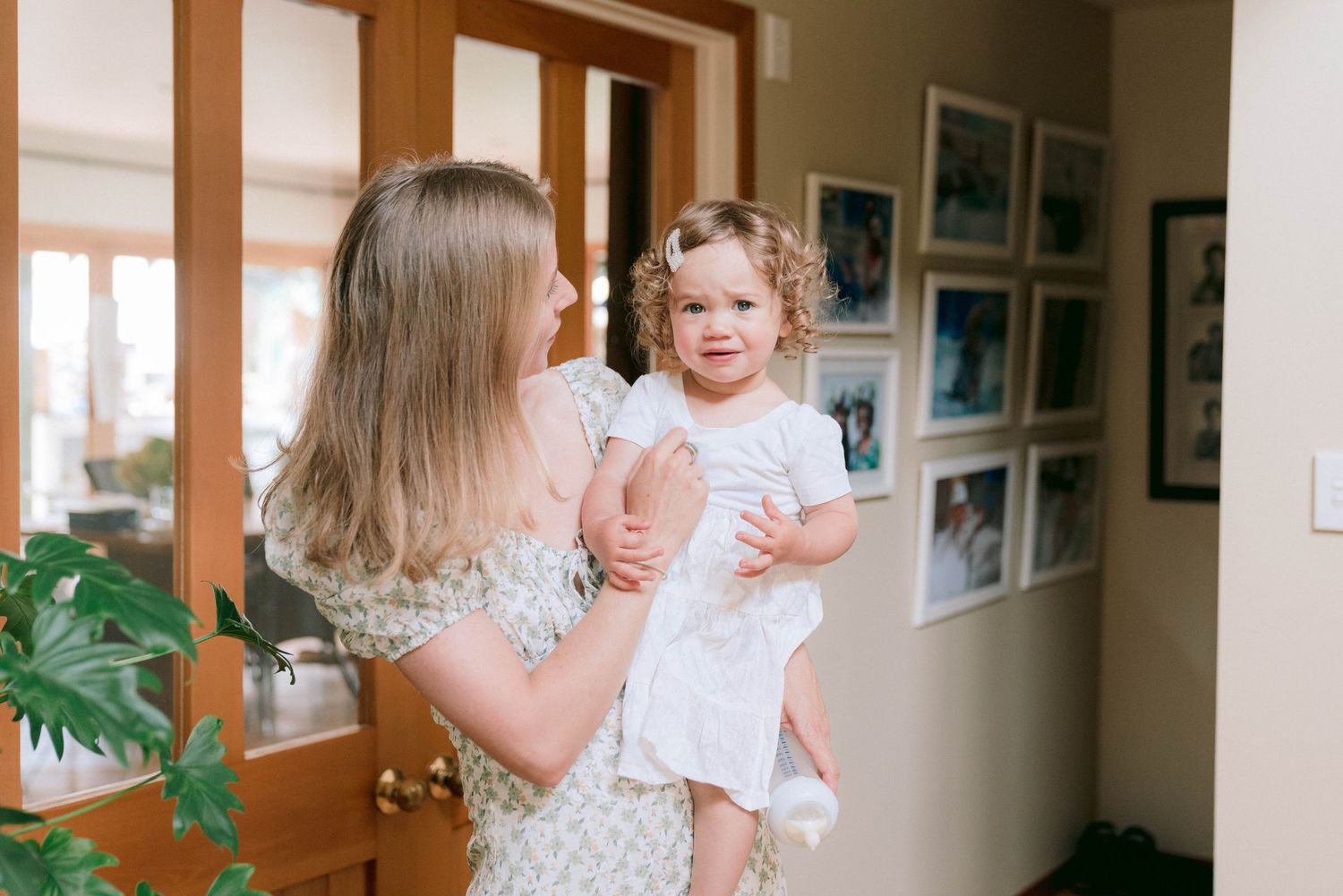 Wedding preparation moments captured in an indoor hallway setting.