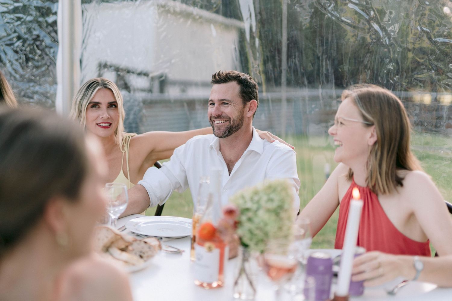 Wedding guests socializing and enjoying drinks at an outdoor reception.