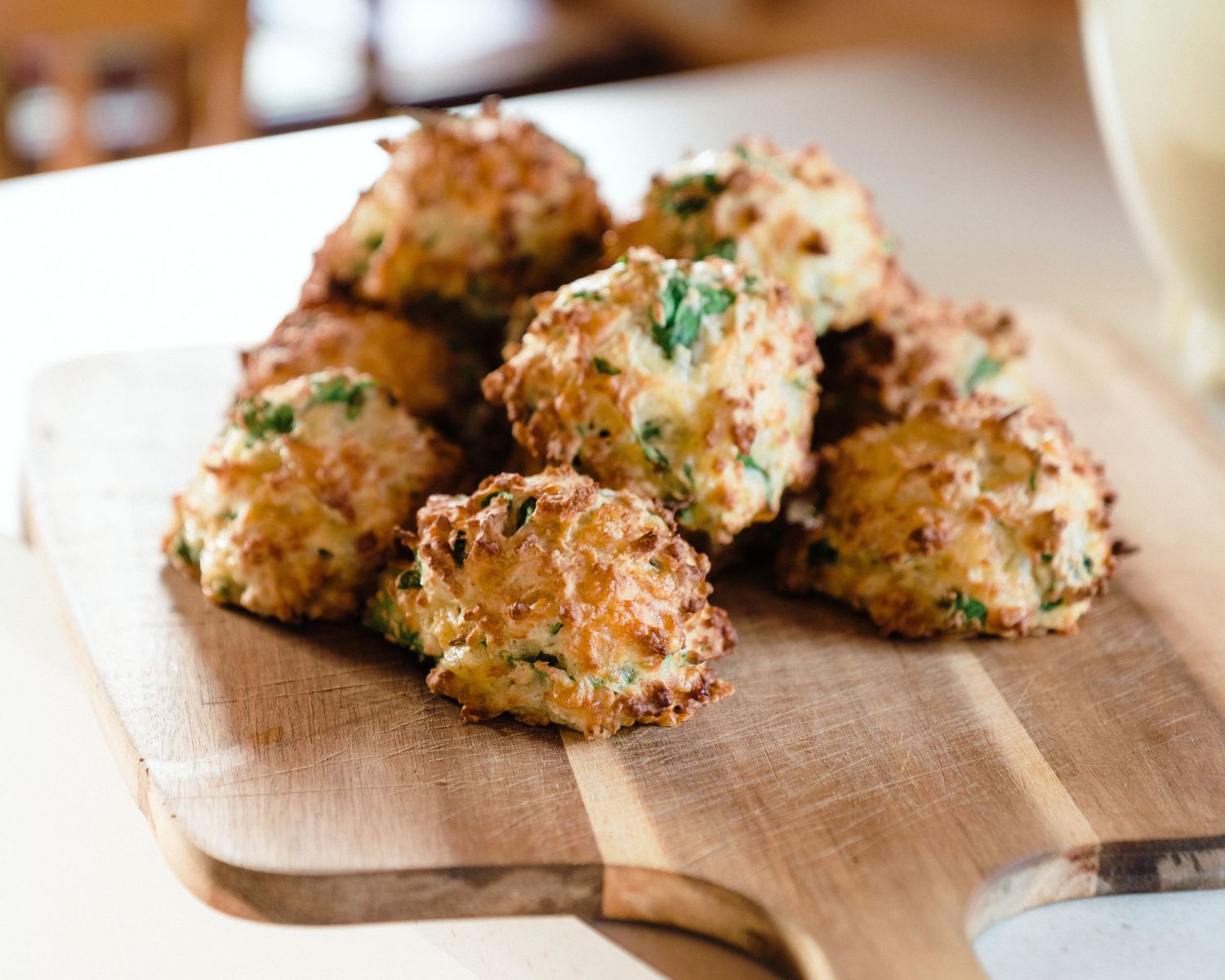 Freshly baked crunchy drop biscuits arranged on a wooden cutting board.