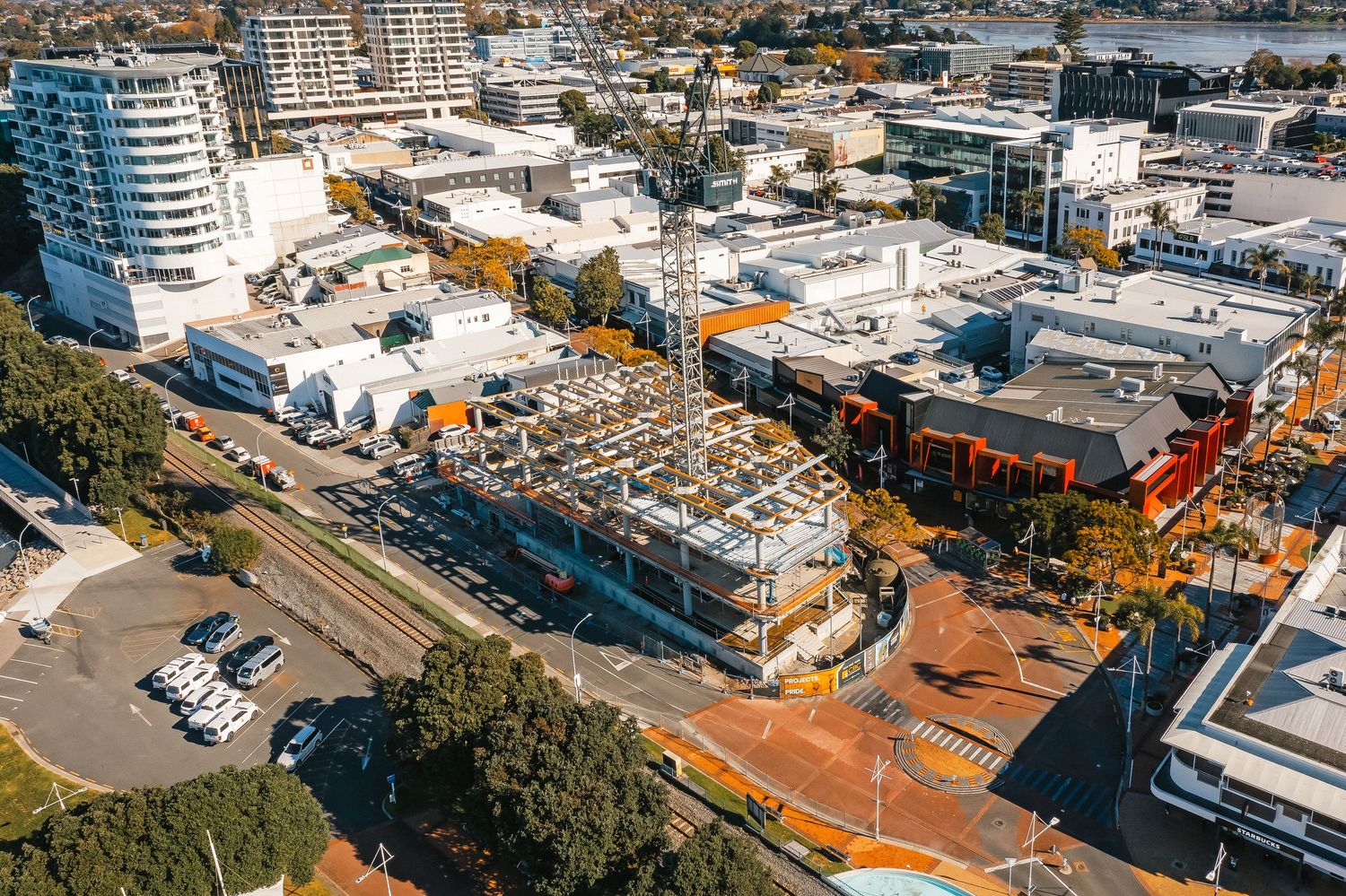 Aerial view of urban development with mixed residential and commercial buildings near waterfront.
