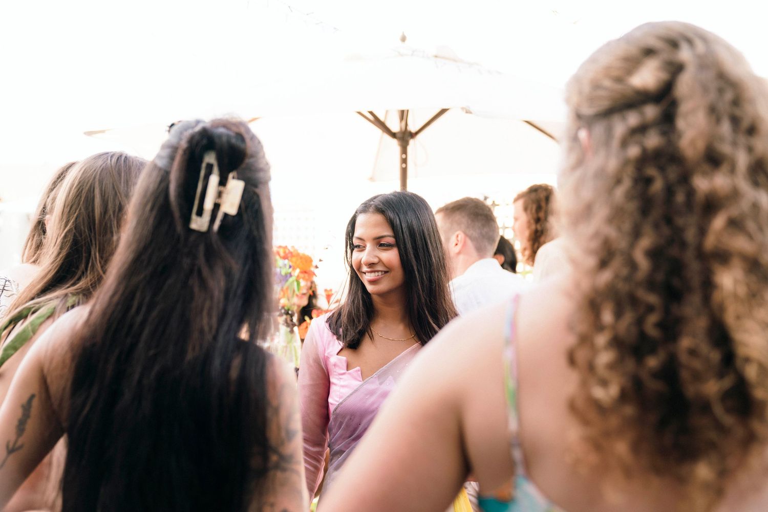 A joyful celebration outdoors with people gathered together on a sunny day.