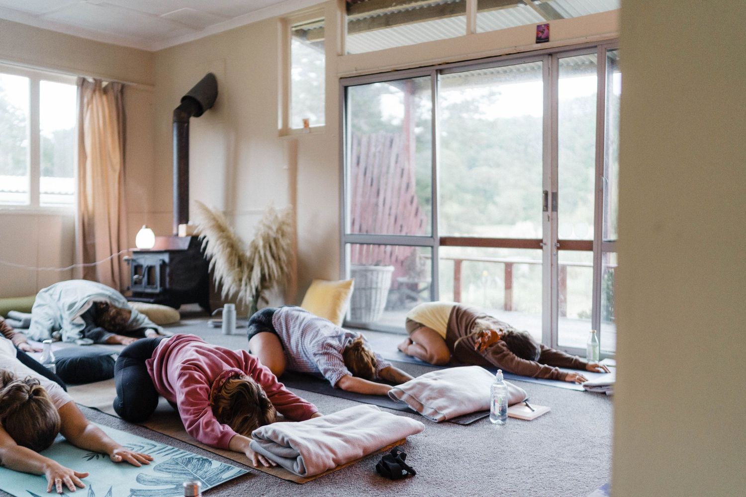 A view of combined sleeping room in a temporary shelter or dormitory with mattresses and blankets arranged on the floor.