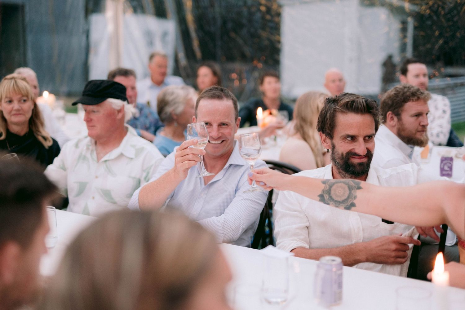 Guests laughing and enjoying themselves at a wedding reception.