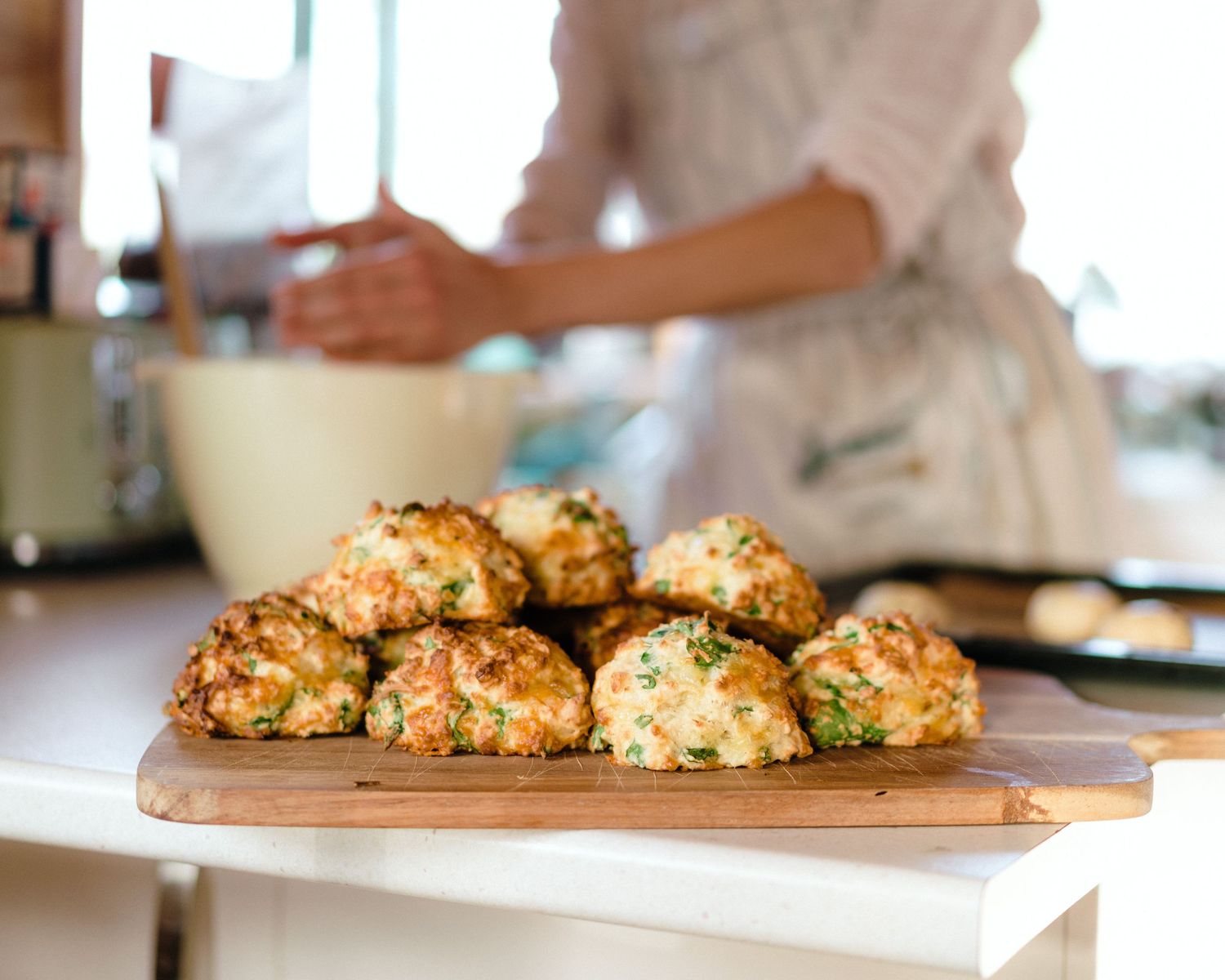 Fresh stuffed mushrooms with herbs and toppings are arranged neatly on a baking sheet ready for cooking.