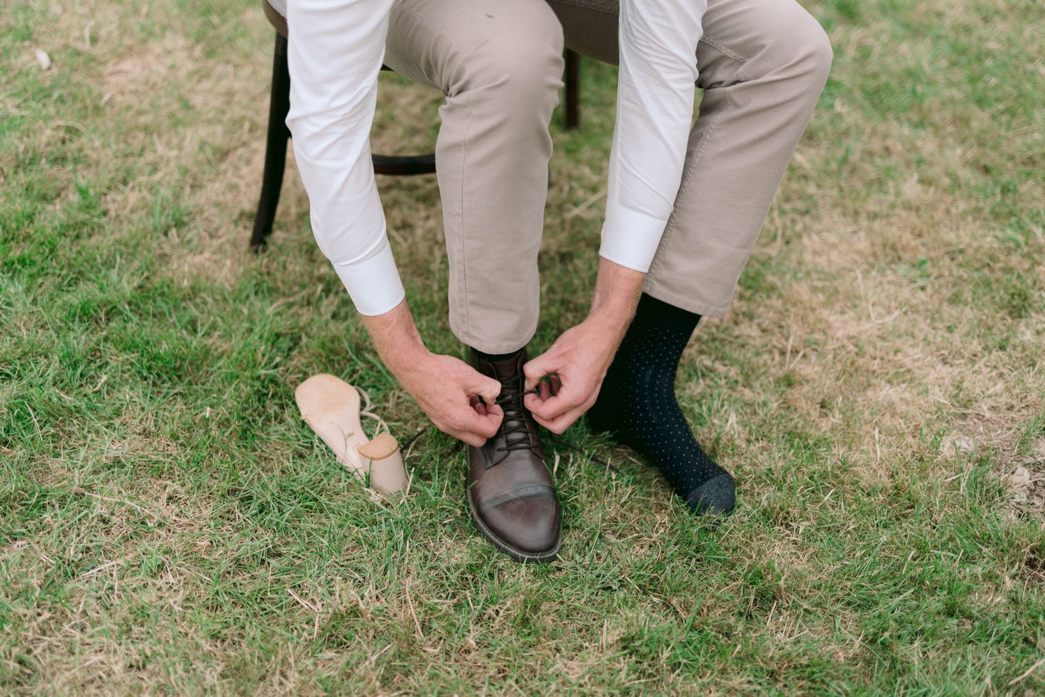 Close-up shots of formal attire and shoes at an outdoor event.