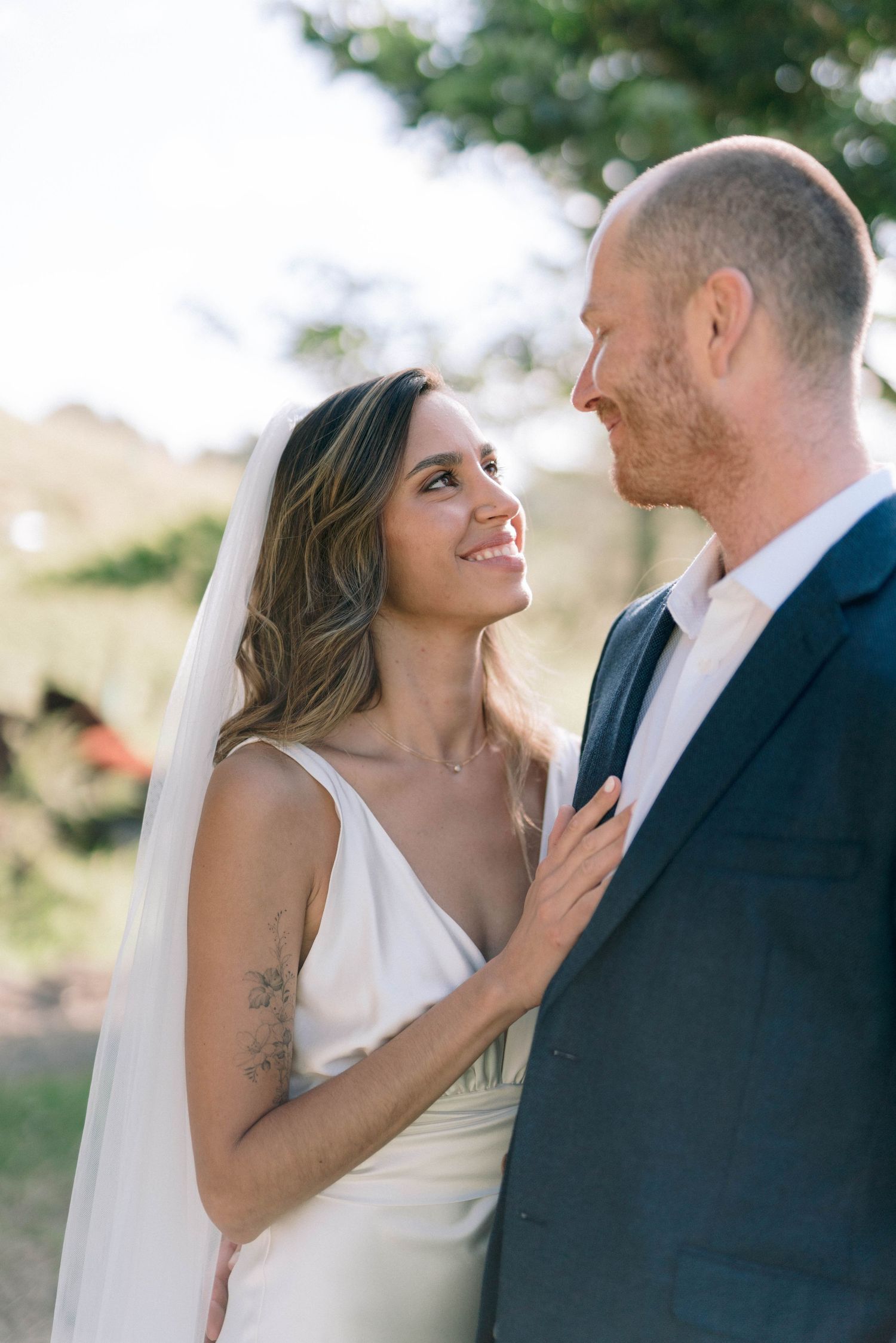 Romantic wedding couple portraits showing tender moments outdoors.