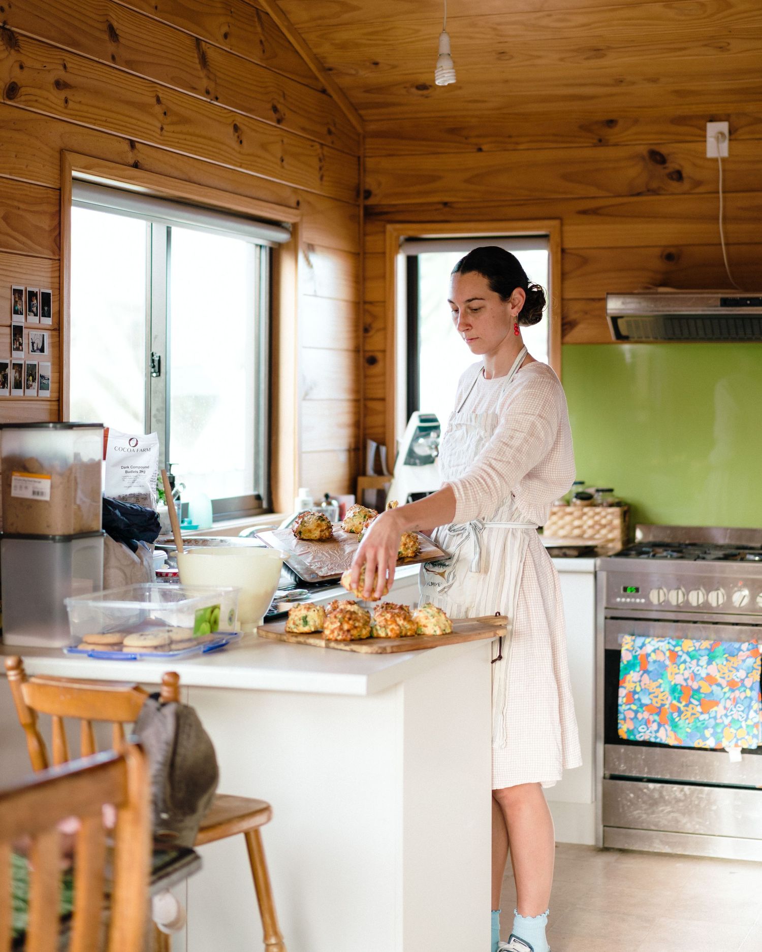 A bright wooden kitchen interior with workspace and cooking activities shown in multiple angles.