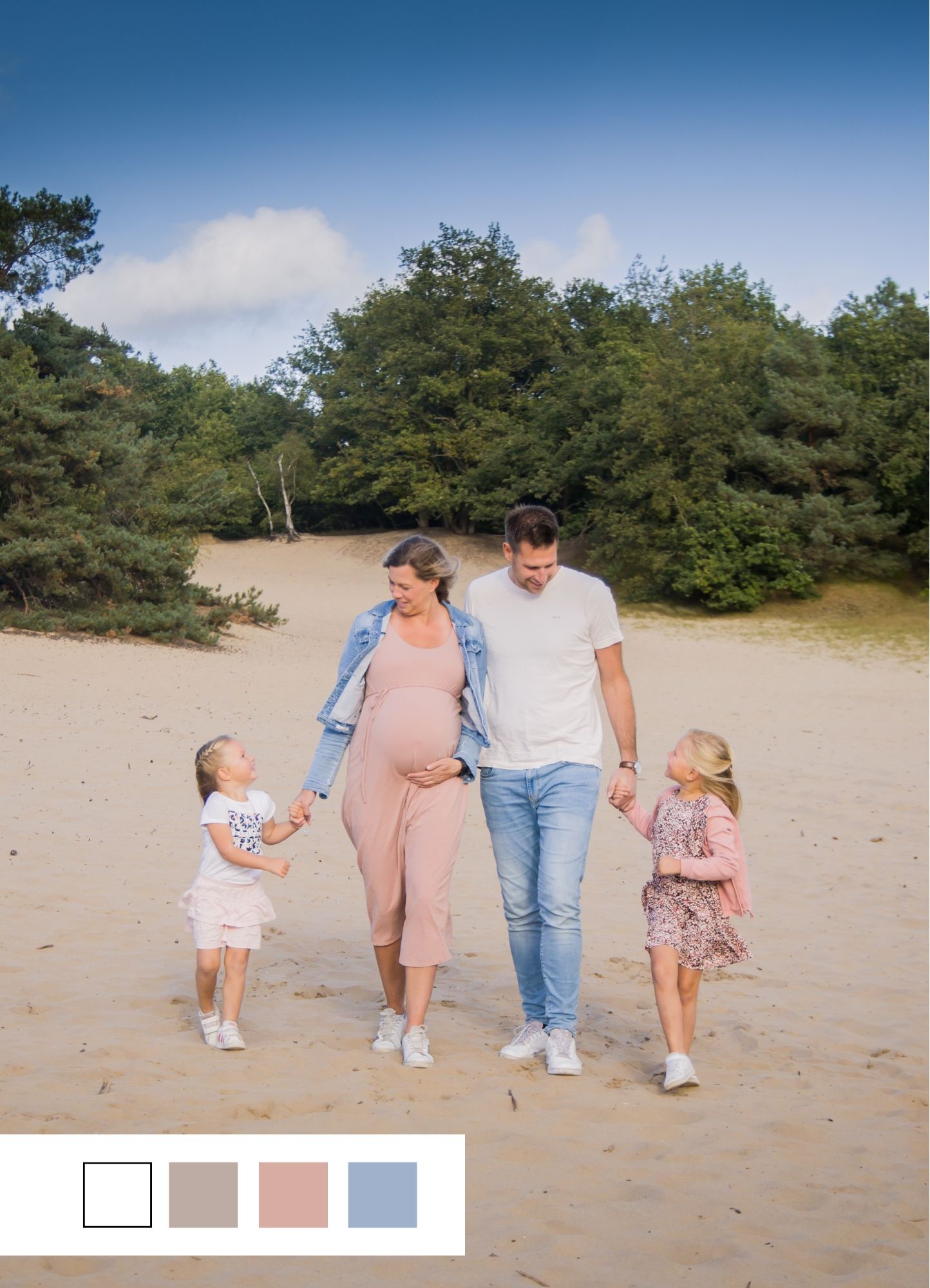 A family strolling together on a sandy beach trail with lush forest backdrop.