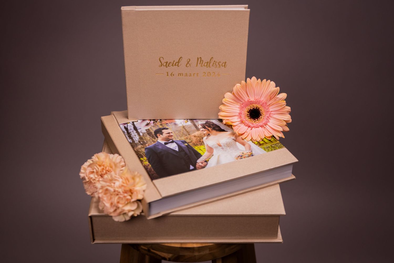 Wedding album box with peach gerbera daisy and photo prints.