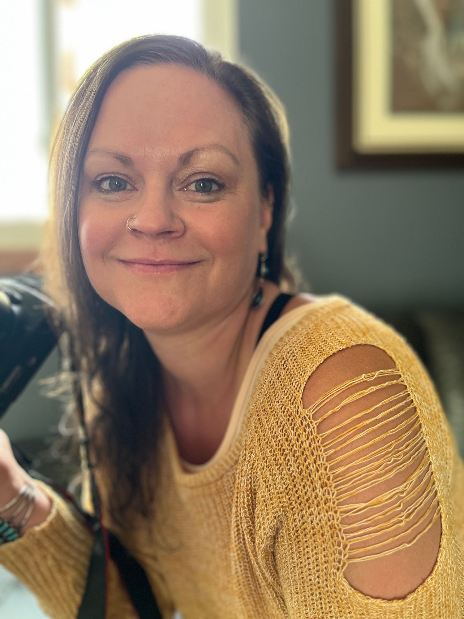 Cassandra Jene, Broomfield Colorado portrait photographer, holding camera during a lifestyle photography session