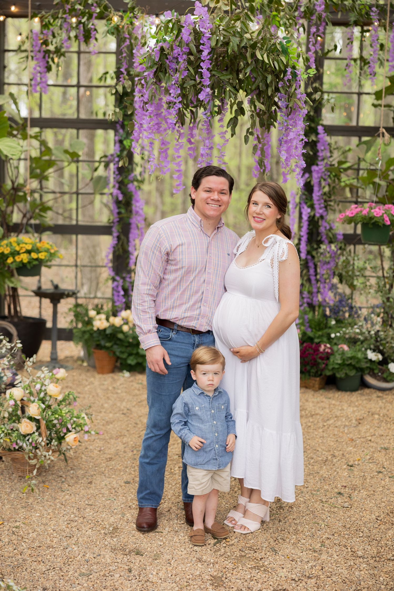 A progressive series of images showing a family posing in front of a garden wall with purple blooming flowers.