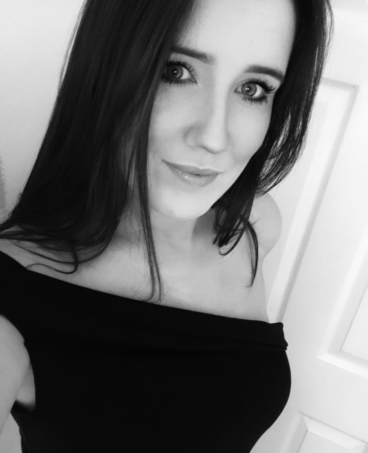 Black and white portrait showing dark hair against white background.