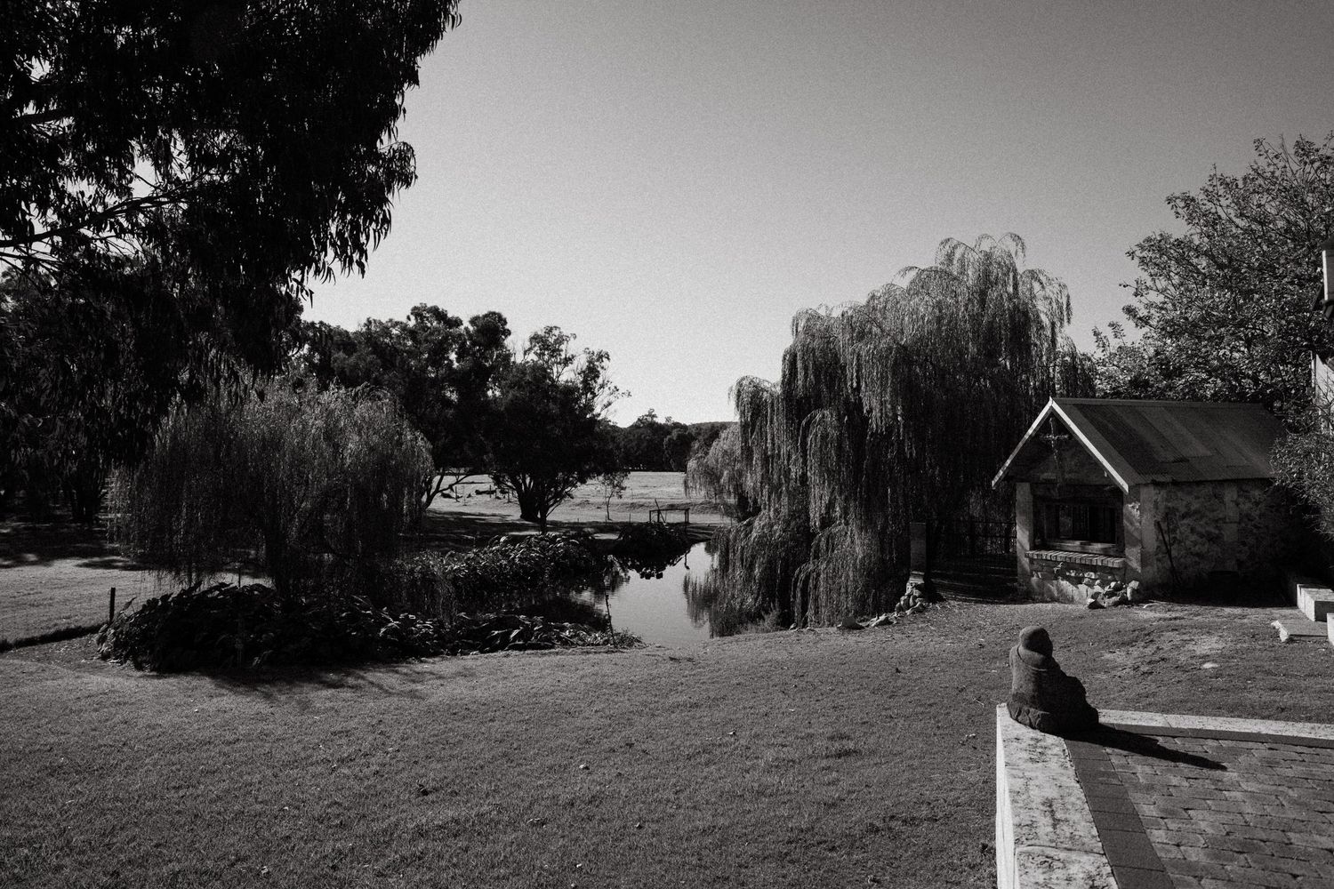 A scenic black and white panoramic view of Perths Chapel Farm Venue in landscape with trees and buildings dotting the countryside.