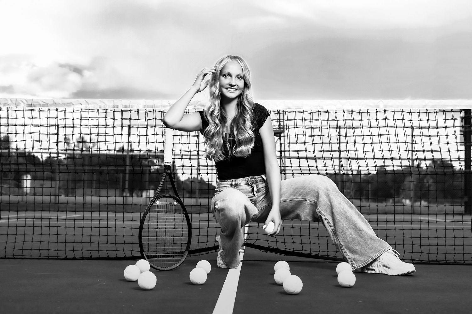 A black and white portrait on a tennis court shows an athletic pose with racquet and casual attire.