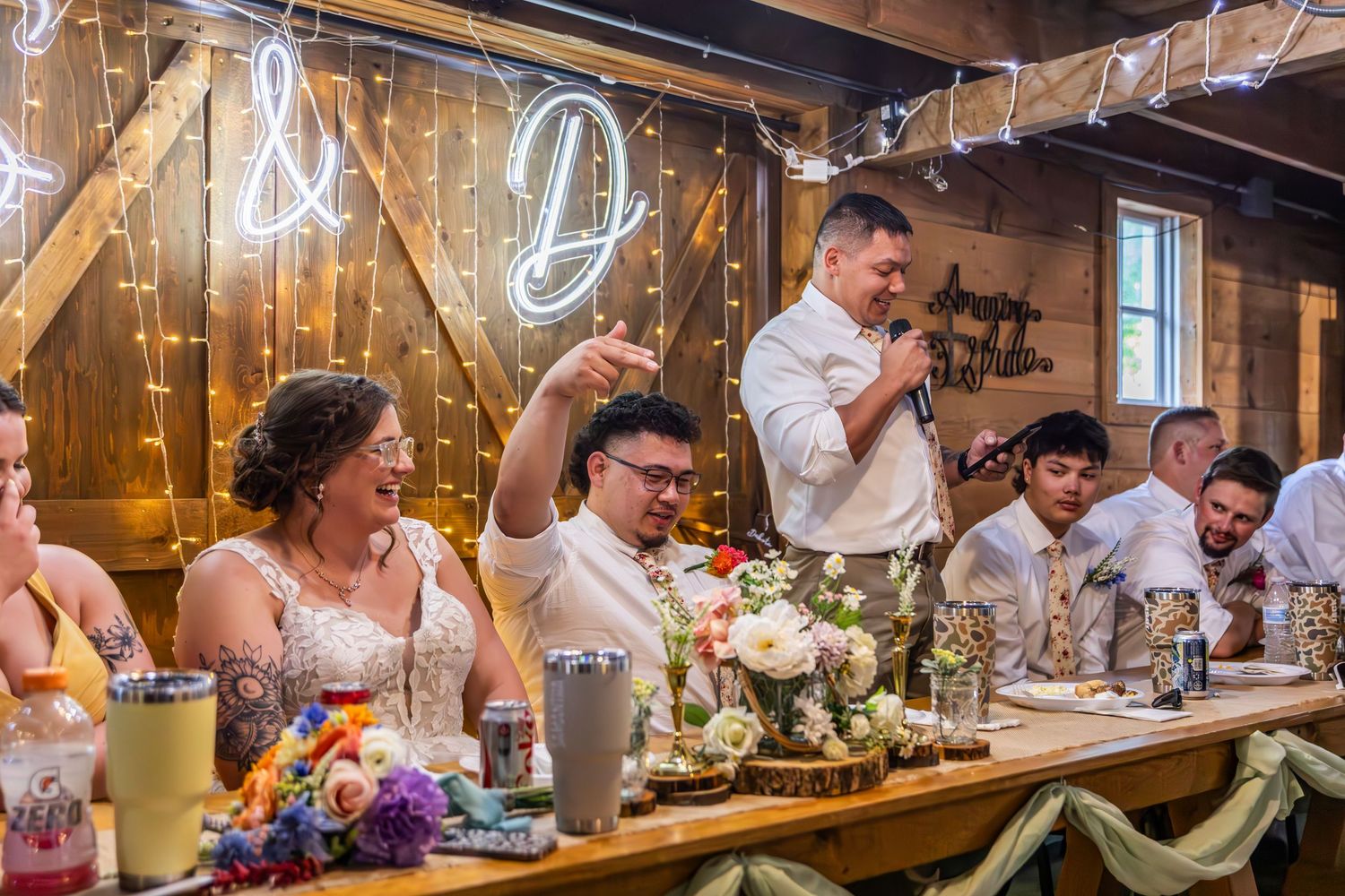 Wedding reception venue decorated with string lights and floral centerpieces creating a warm ambiance.