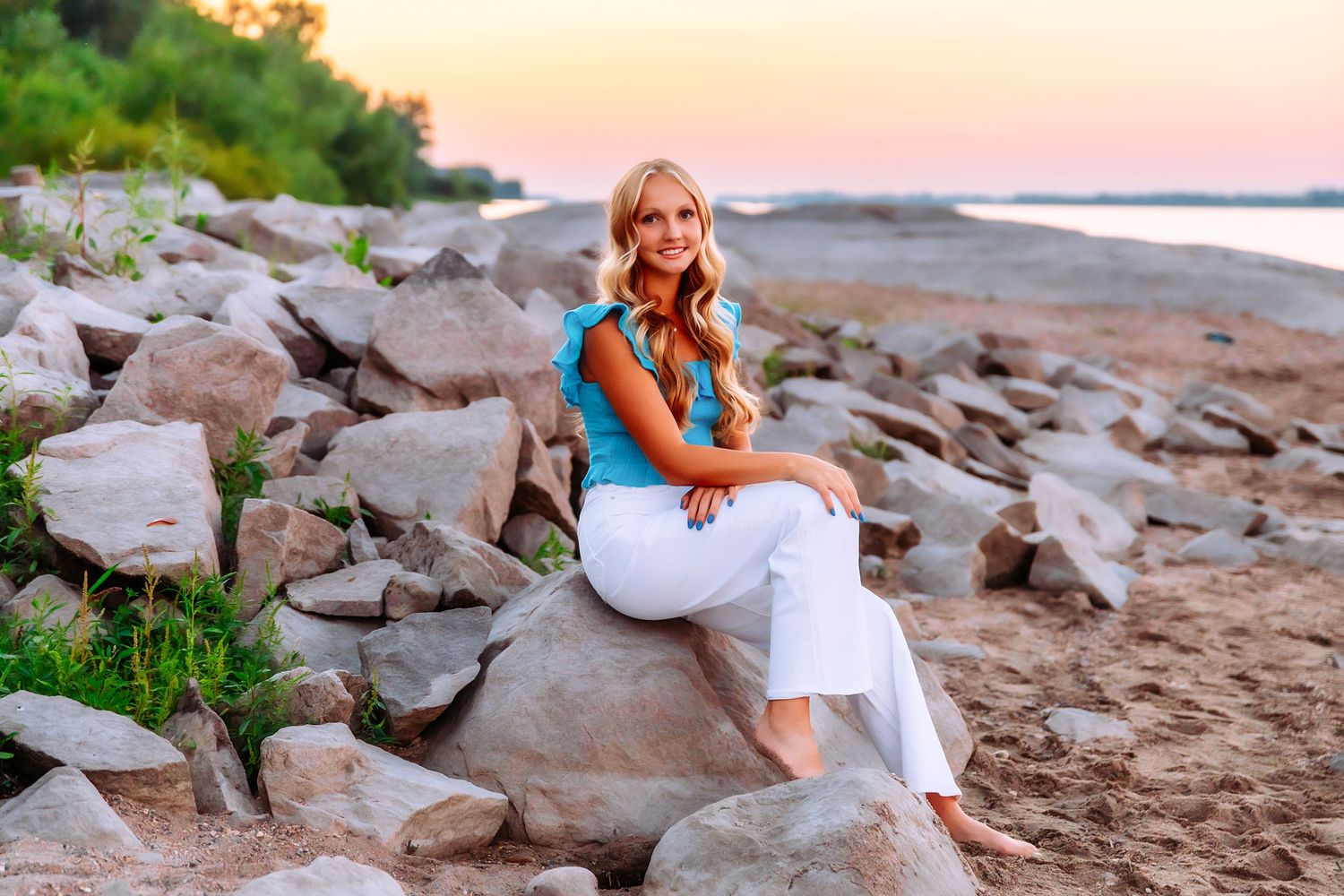 Portrait session on rocky beach during golden hour sunset.