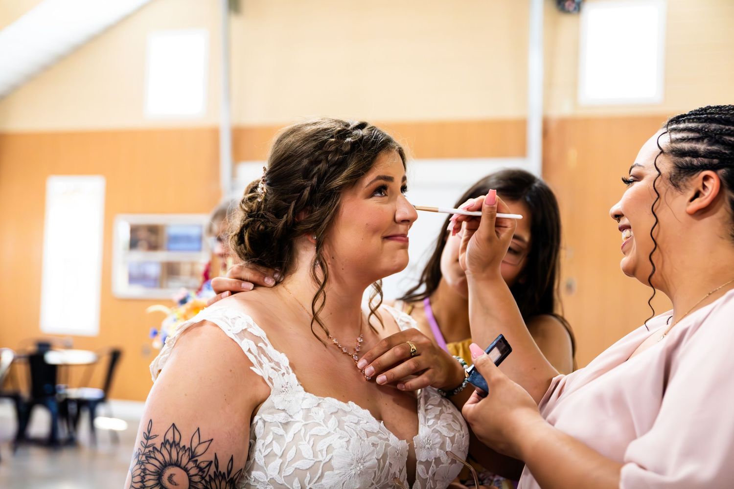 Emotional moment during wedding preparation as makeup is being applied.
