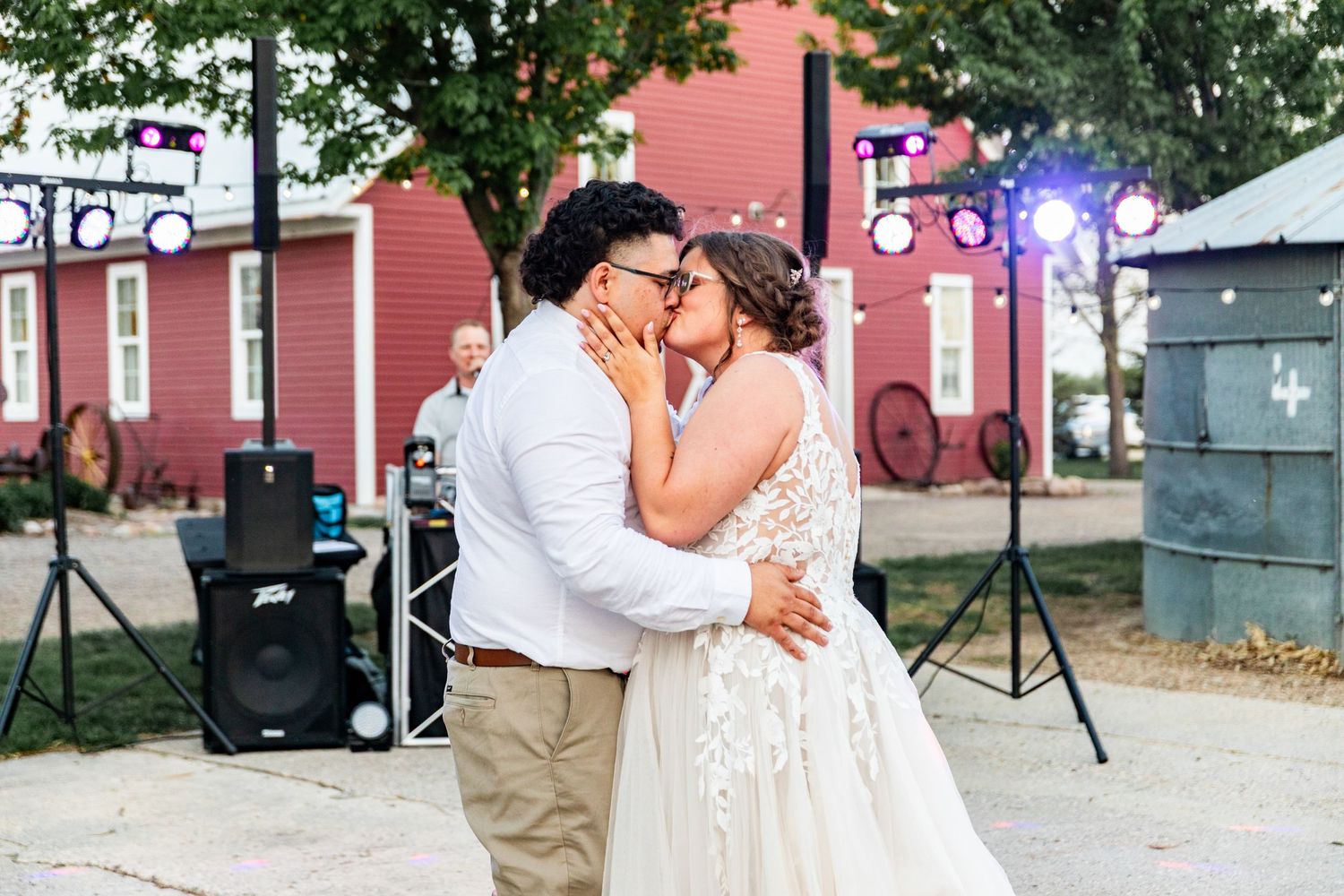 Romantic moment shared during a first dance at an outdoor wedding reception.