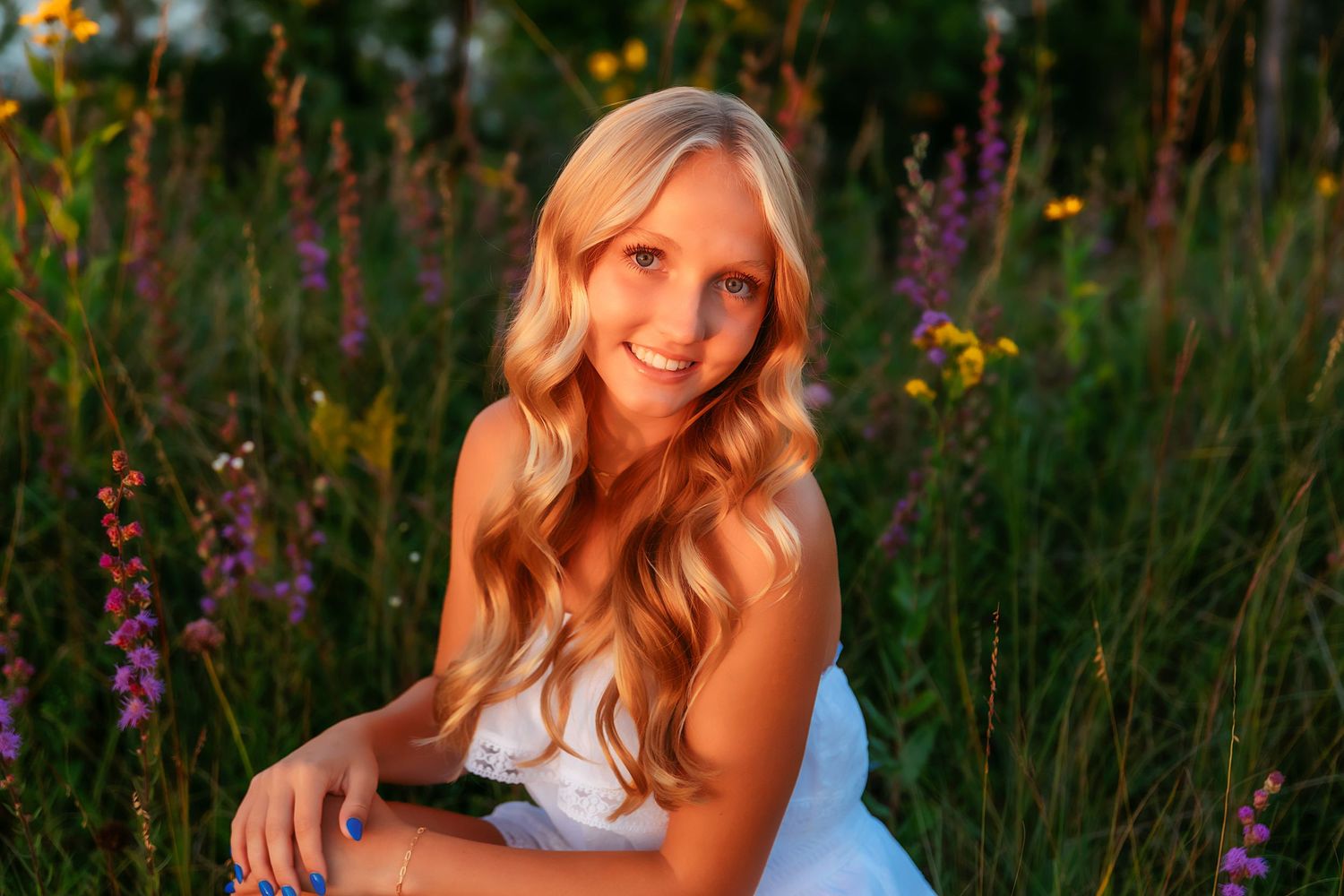 A summertime portrait amongst vibrant wildflowers and natural light captures a joyful outdoor moment.