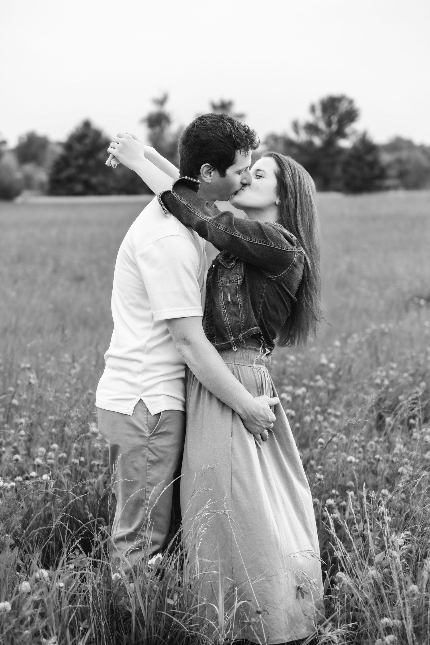 Black and white romantic sequence of a couple embracing in a wildflower field.