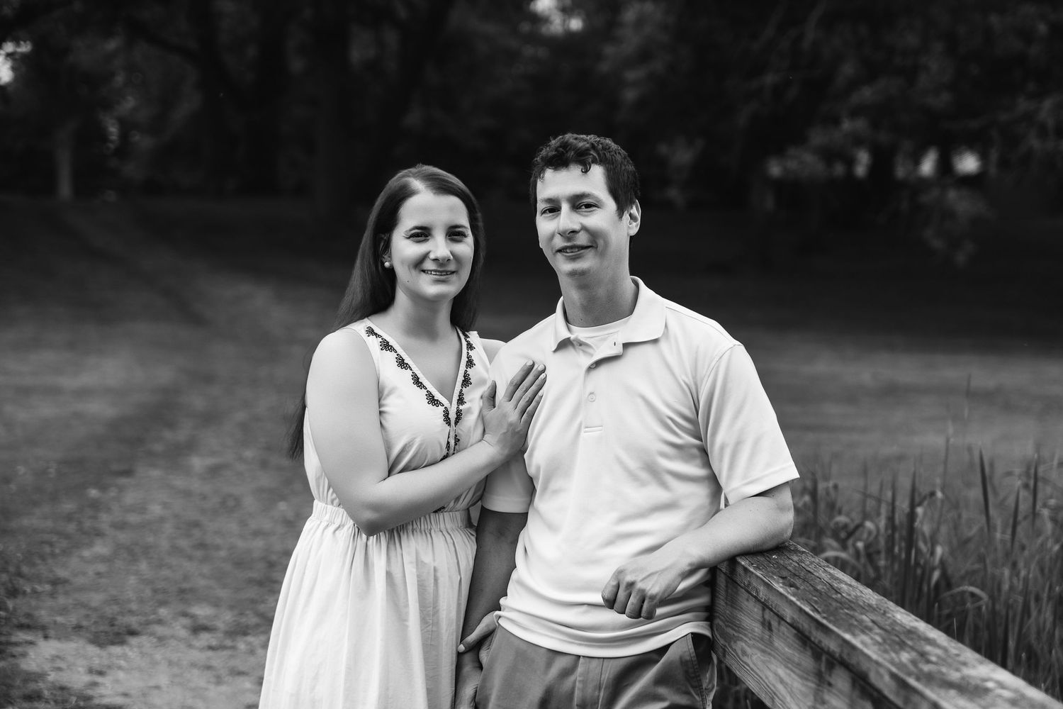 Couple sitting together and sharing intimate moments on a wooden deck.