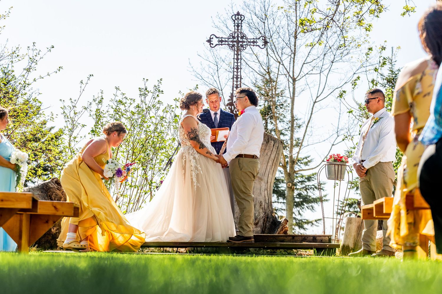 A wedding party plays croquet on a sunny outdoor lawn during an elegant garden reception celebration.