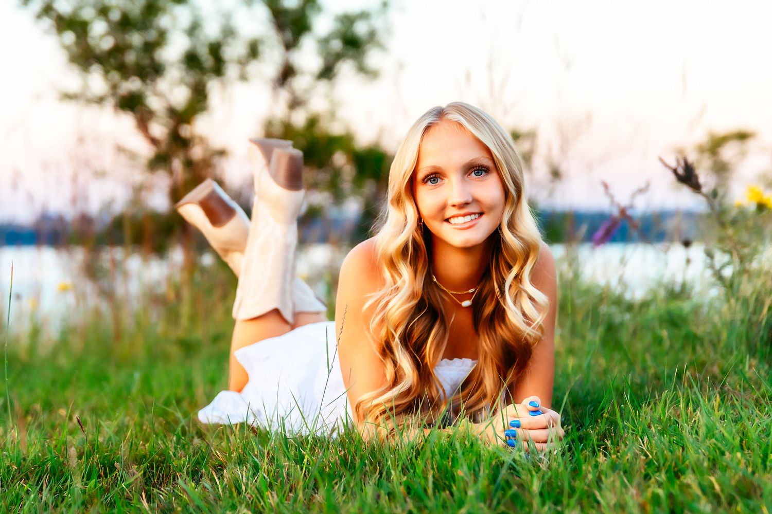 A relaxed outdoor portrait in a grassy field during sunset captures a casual summer mood.