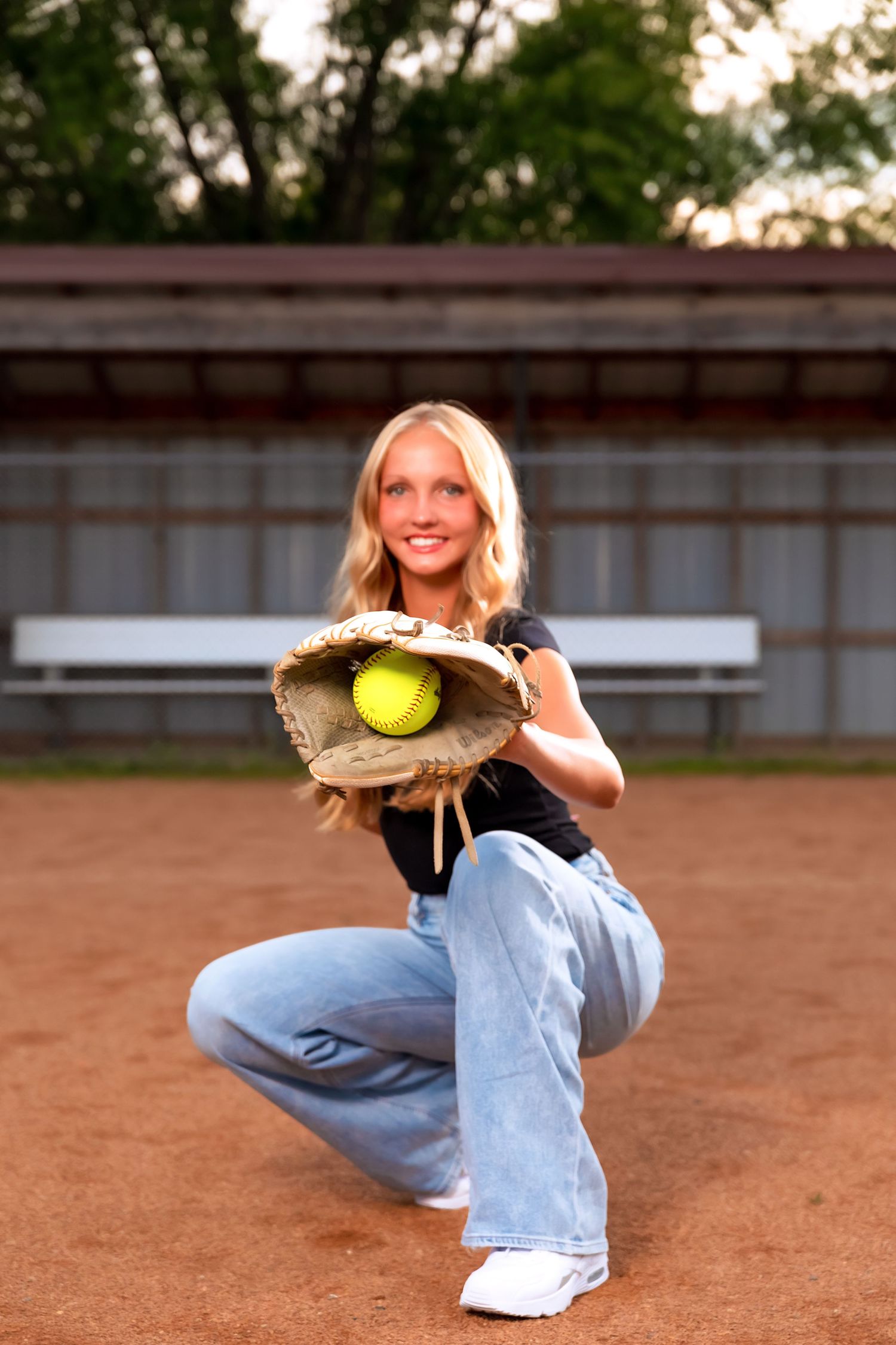 Sport themed photo series on a dirt softball field with tennis balls and athletic poses.