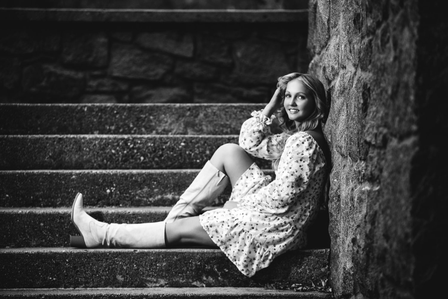 Black and white portrait on stone steps with vintage aesthetic.
