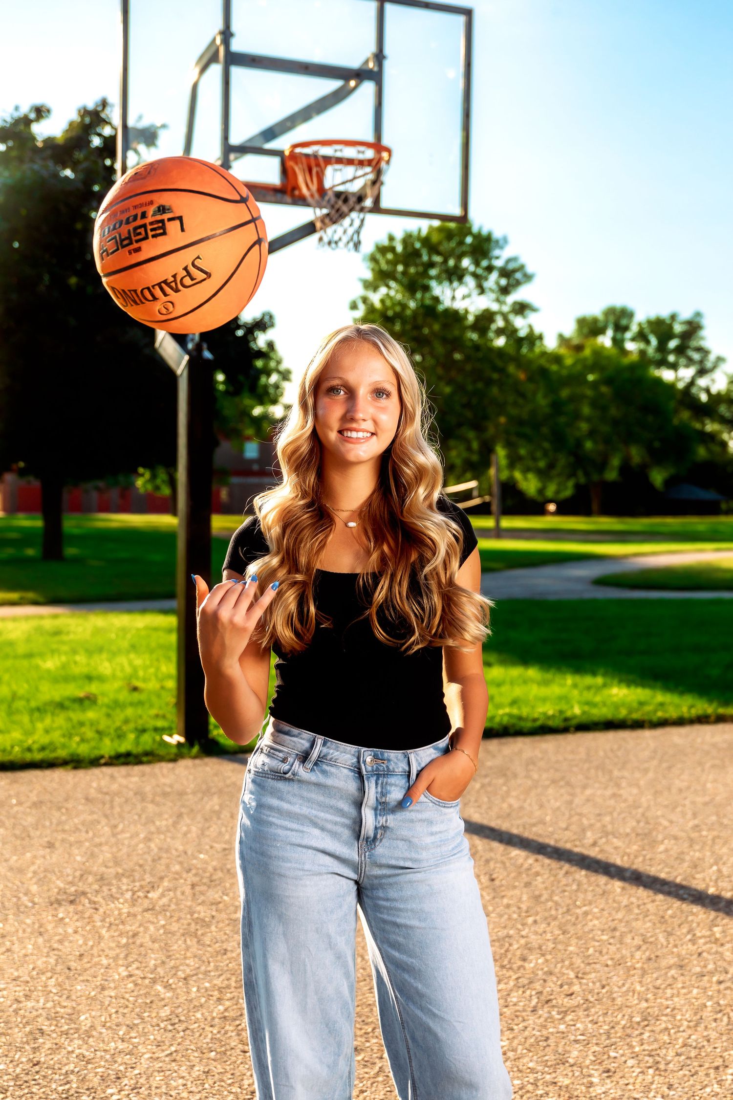 Playful basketball court photo series showing tricks with orange basketballs and casual denim style.