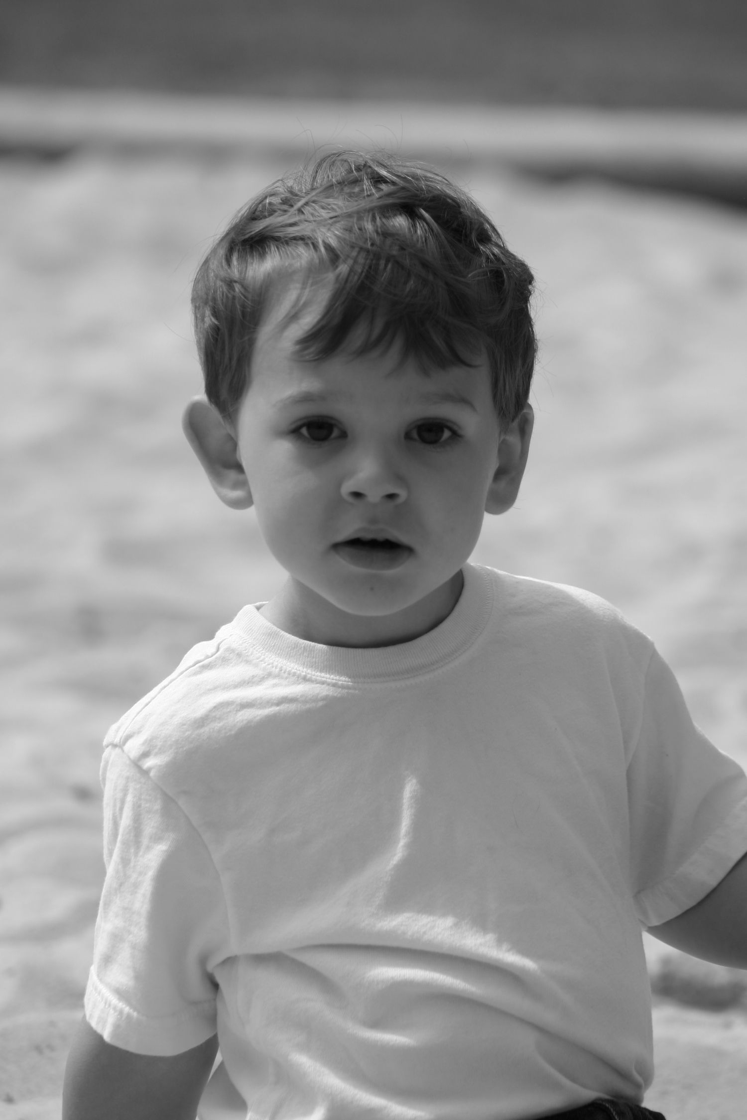 Candid B&W portrait of expressive young boy in natural light at Stone Mountain park. Warm and tender. Photography by Rachel.
