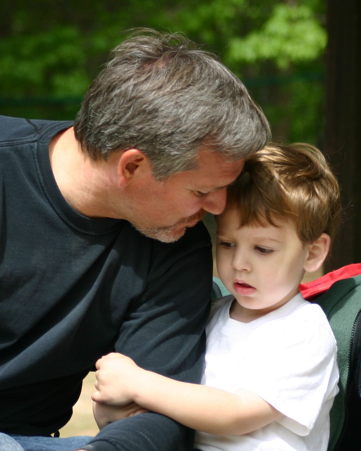 Tender father and toddler moment in soft natural light at Stone Mountain, GA. Emotional, scroll-stopping image.
