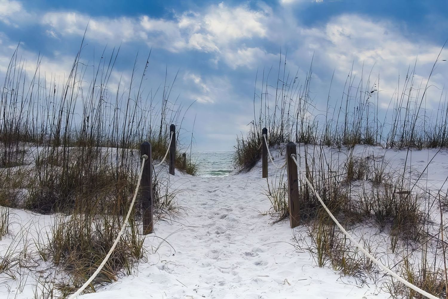Fine art beach photo, Destin FL—sandy path over dunes, white rope fence, blue sky & gulf in view. Peaceful & inviting. Photography by Rachel