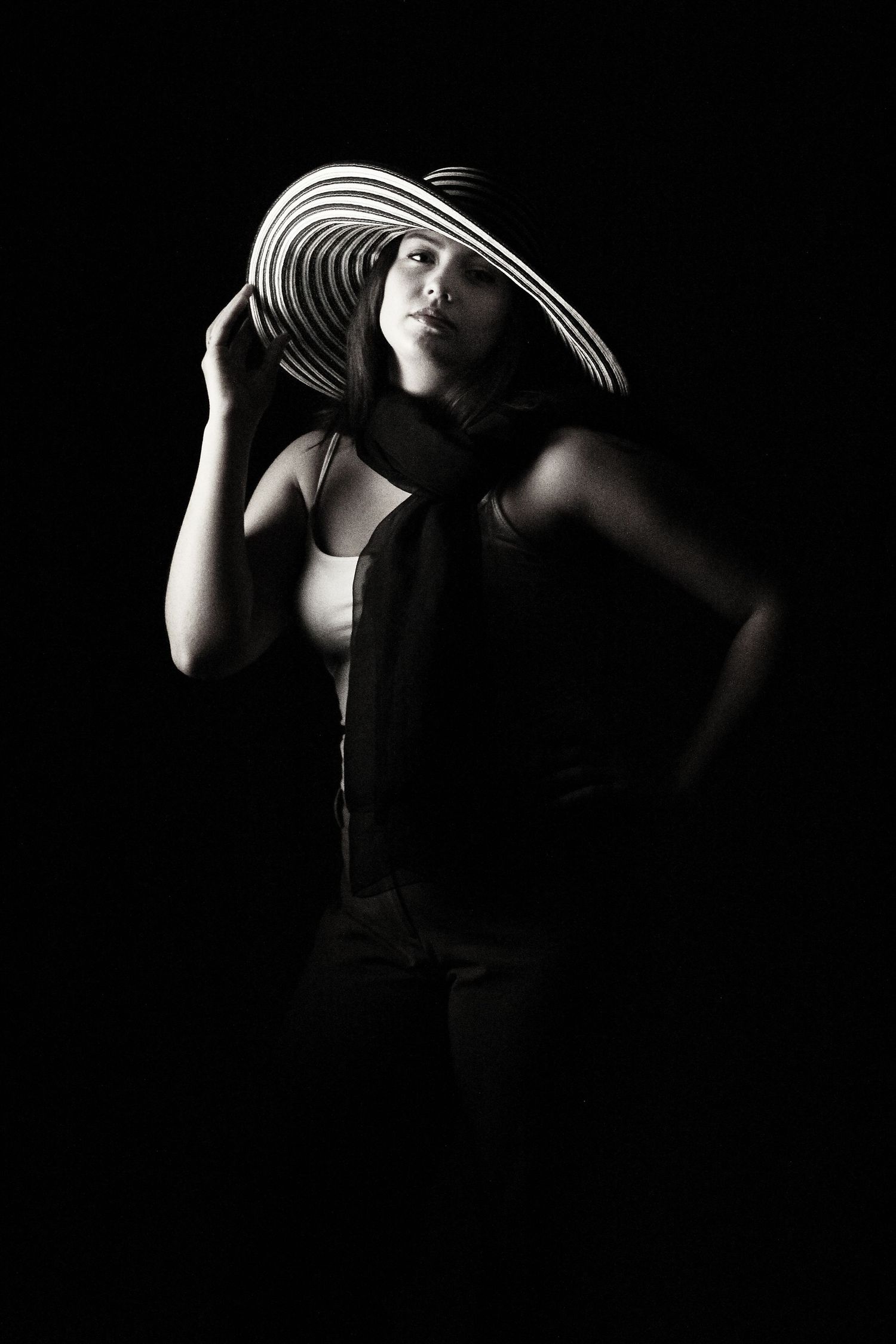 Black & white portrait of young woman in dramatic wide-brim striped hat—classic Hollywood glamor. Photography by Rachel, Pensacola, FL.
