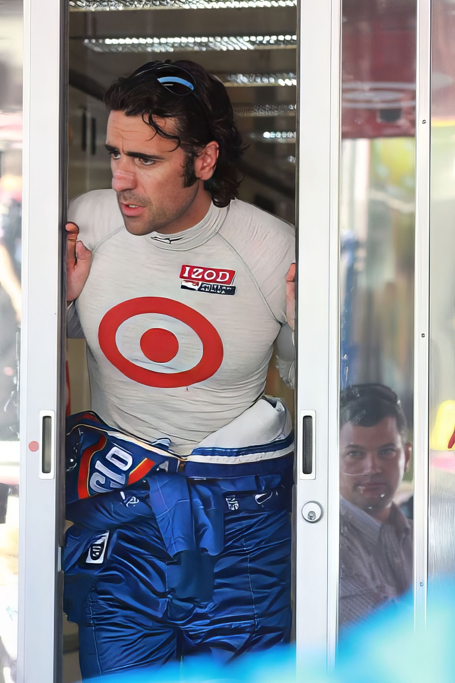 Paparazzi-style candid of Franettie, Target Formula 1 driver, looking out sliding door pre-race. Photography by Rachel.