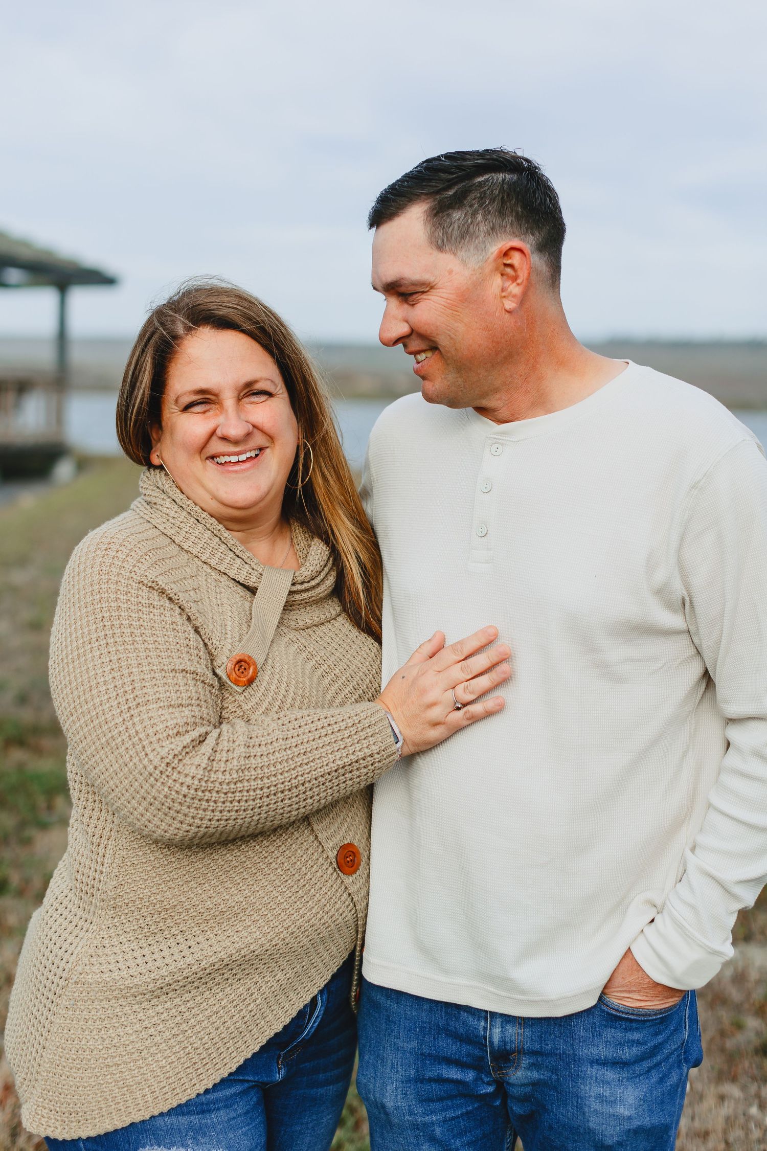 Couple in casual winter wear sharing a tender moment outdoors.