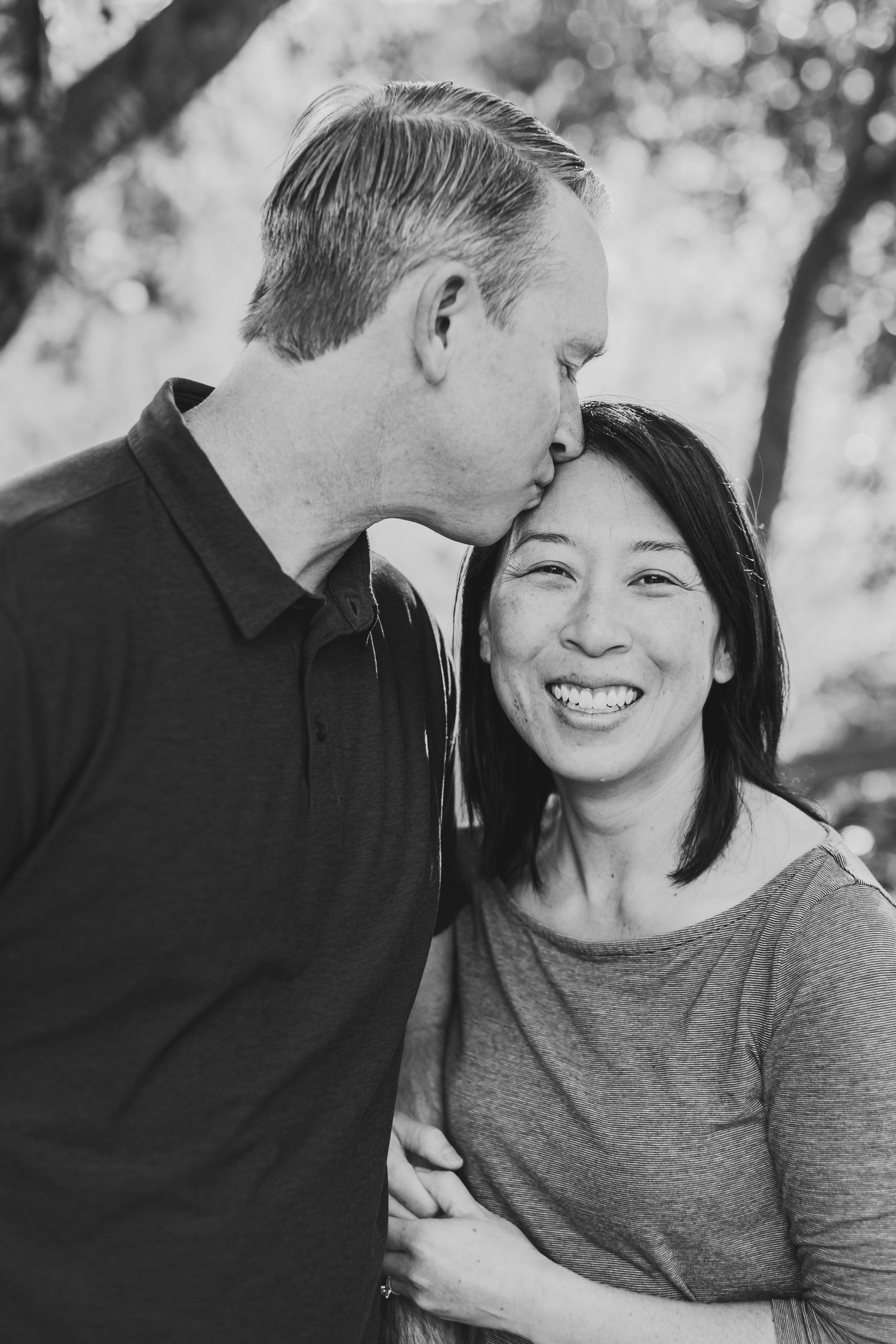 A sweet black and white portrait capturing a loving moment between partners.