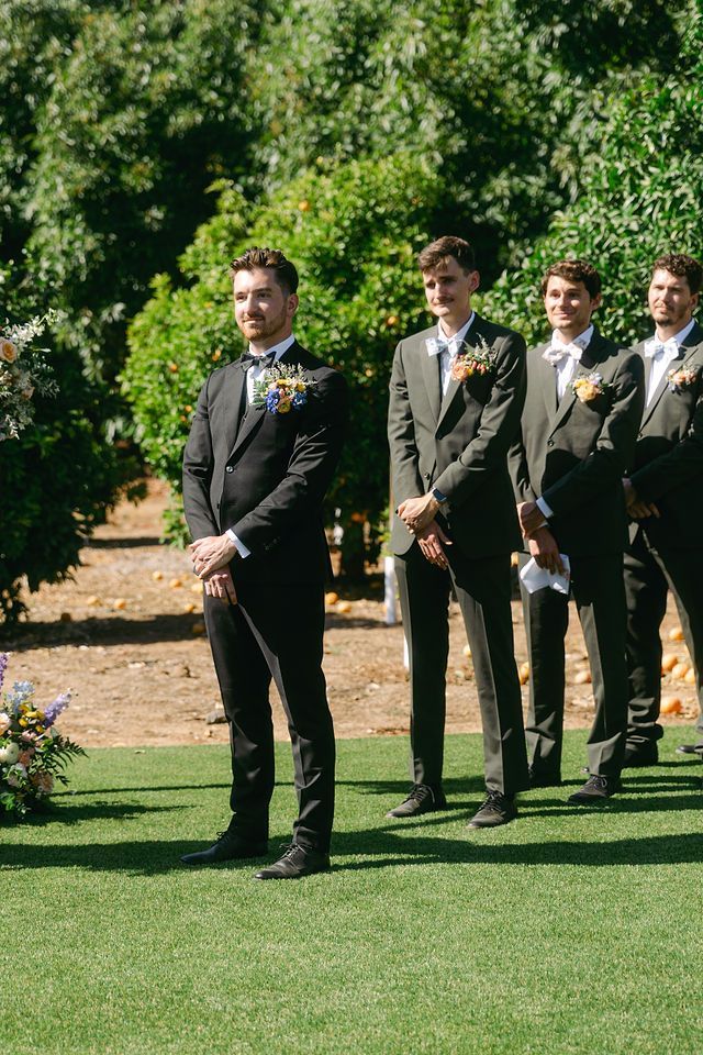 Exchange of wedding rings during outdoor ceremony.