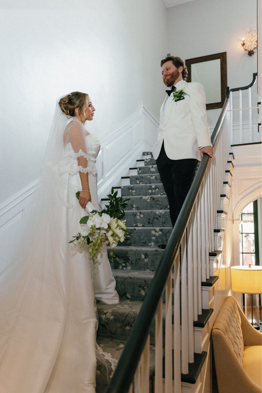 A progression of candid wedding moments captured on an elegant staircase with dark railing and gray carpet.