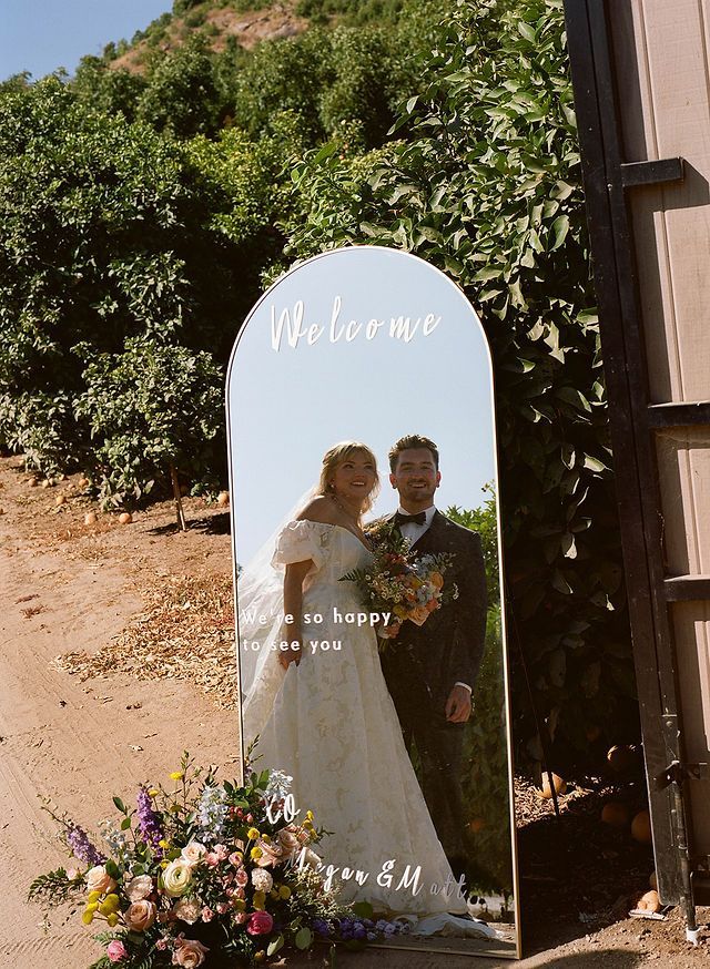 Wedding couple under canopy with 'Just Married' banner.