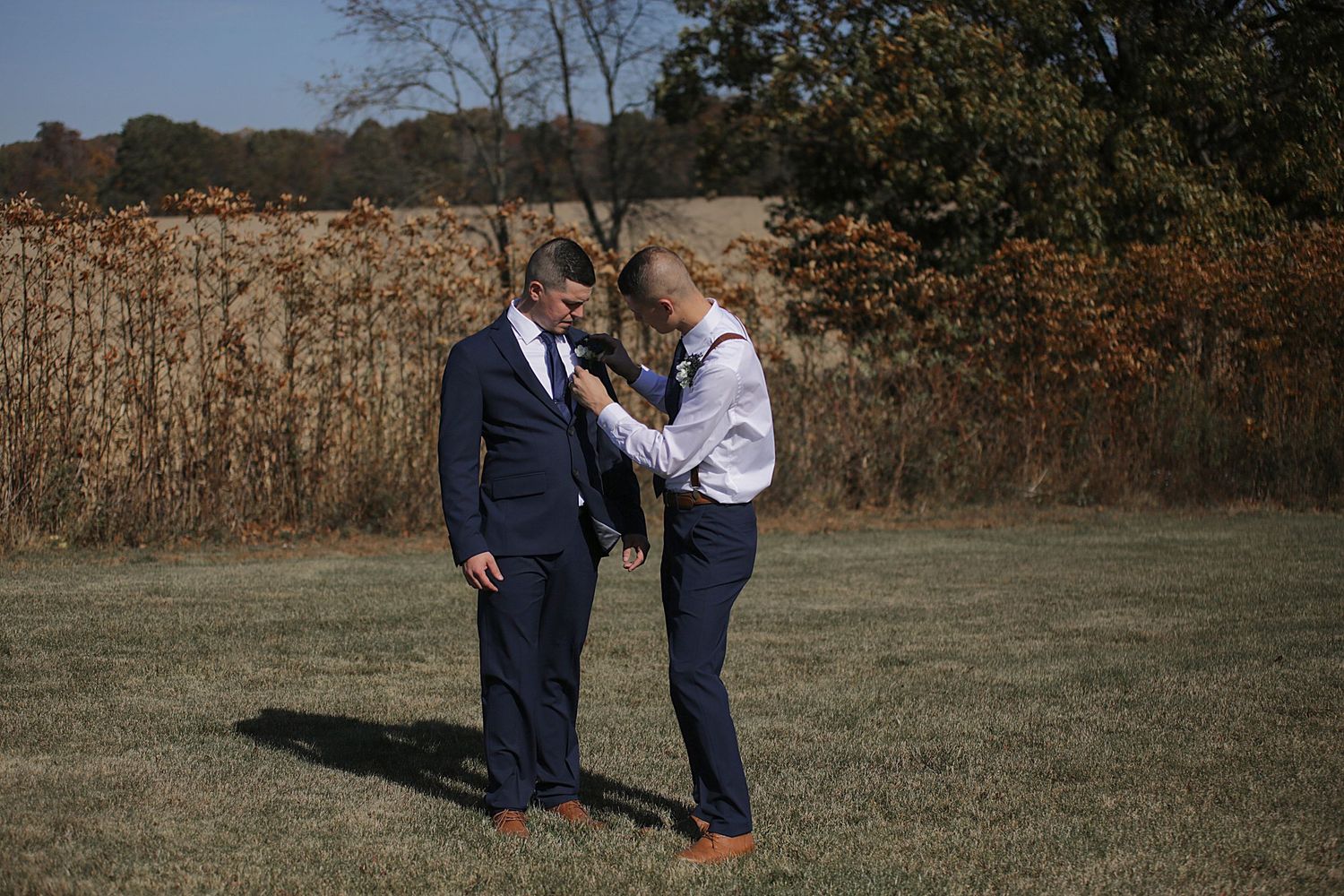 Intimate outdoor wedding moments captured against rustic fall backdrop.