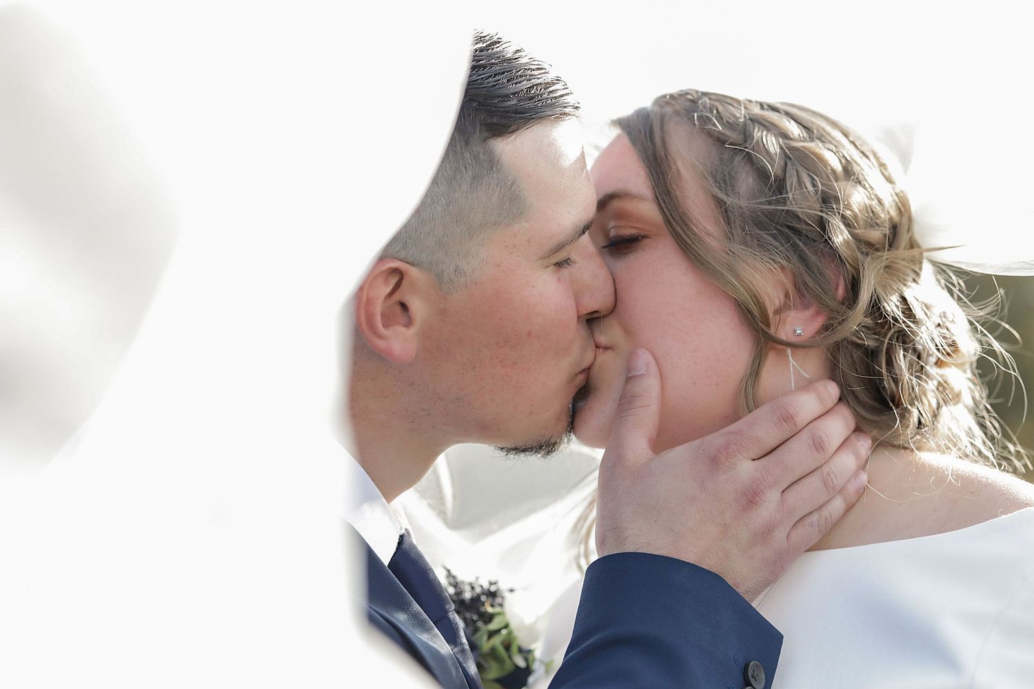 Romantic close-up wedding portrait against soft blurred background.