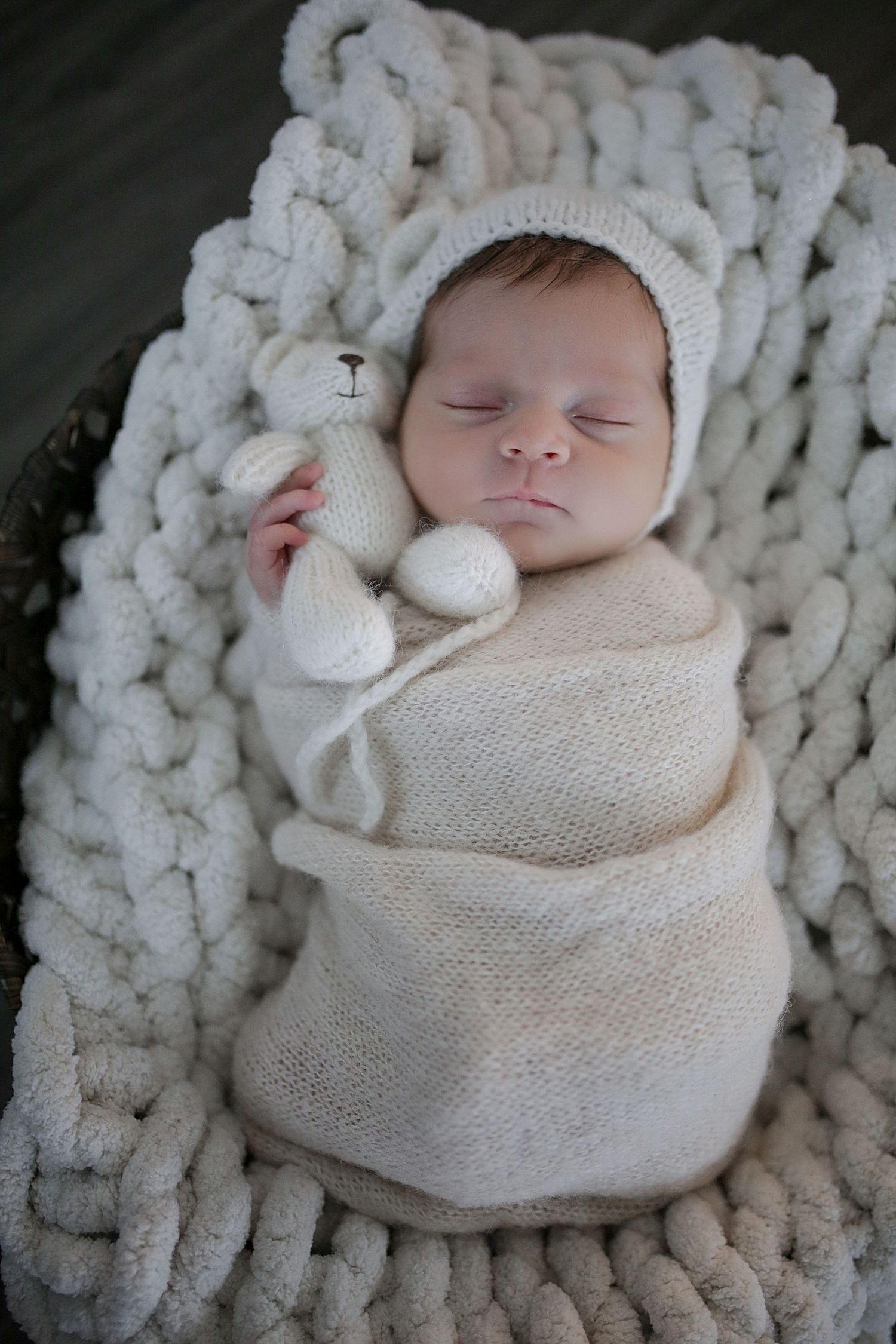 Adorable sleeping newborn wrapped in cream knit blanket on chunky knit backdrop shown from multiple angles.