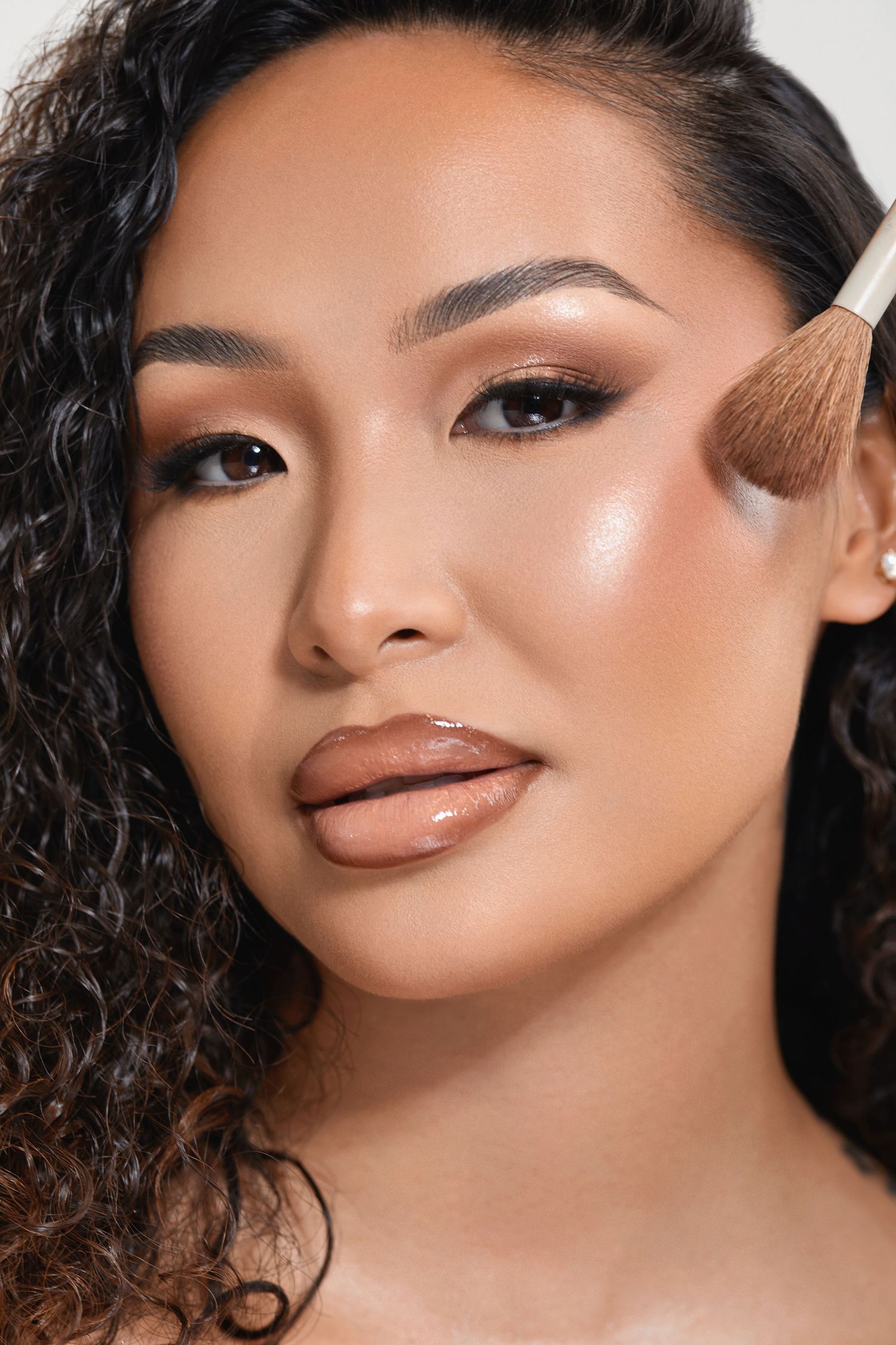 Professional makeup application showcase highlighting glowing, radiant complexion.