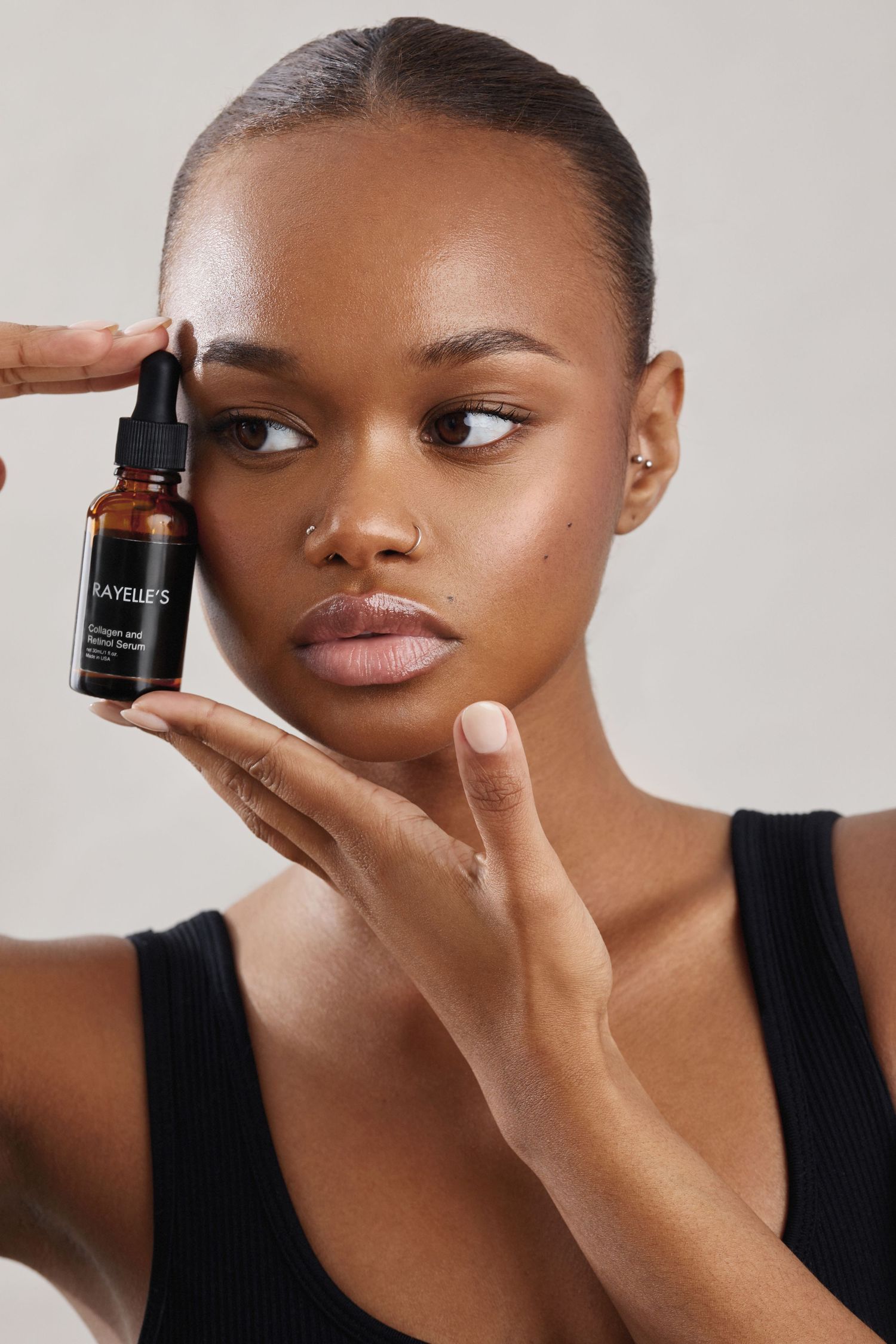 Close-up beauty shots demonstrating skincare product application on dark skin.