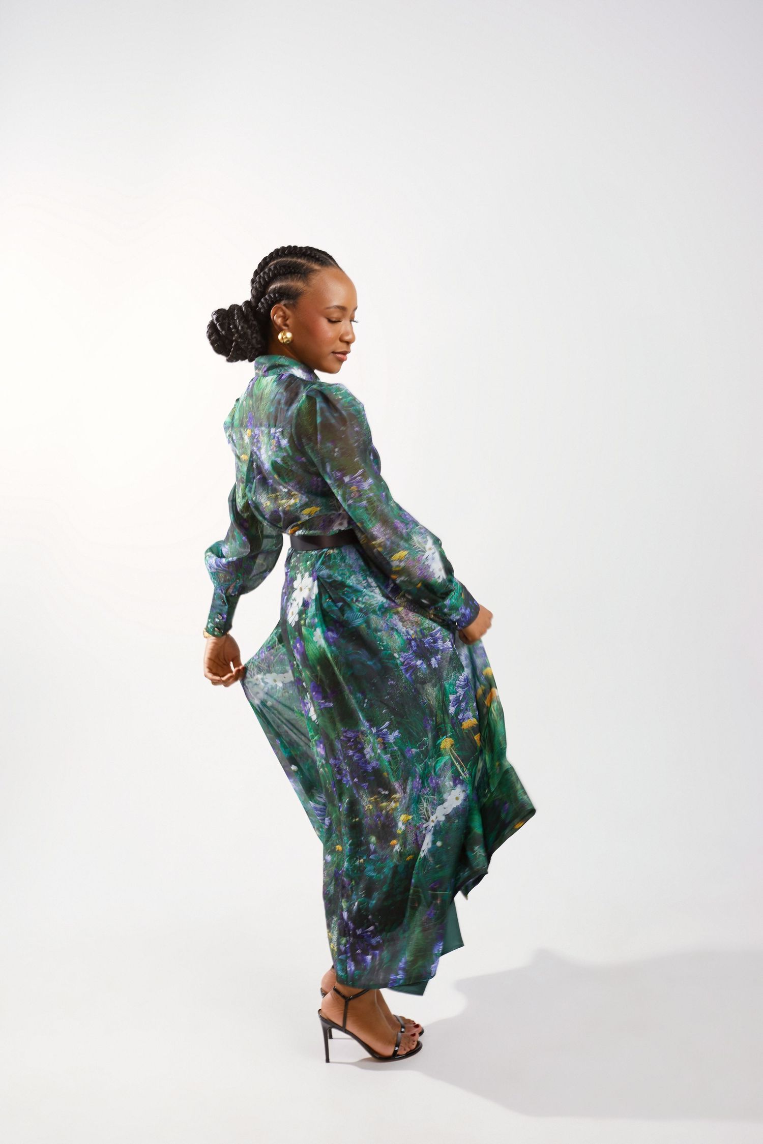 Artistic fashion shots in flowing green and purple floral dress against white backdrop.