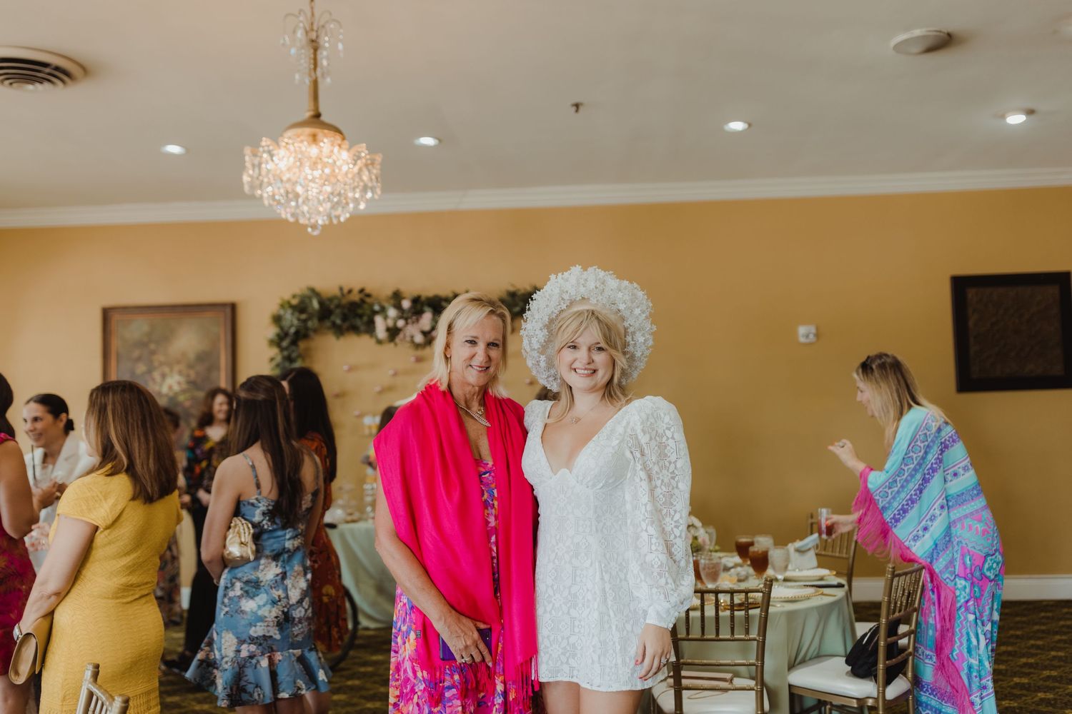People enjoy dancing together at an indoor social event with elegant decor and warm lighting.